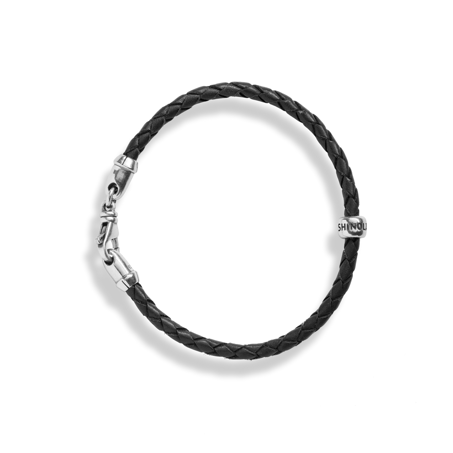 The Shinola Single Wrap Woven Leather Bracelet in black features a sterling silver clasp and a small silver bead engraved with SHINOLA, shown against a plain white background.