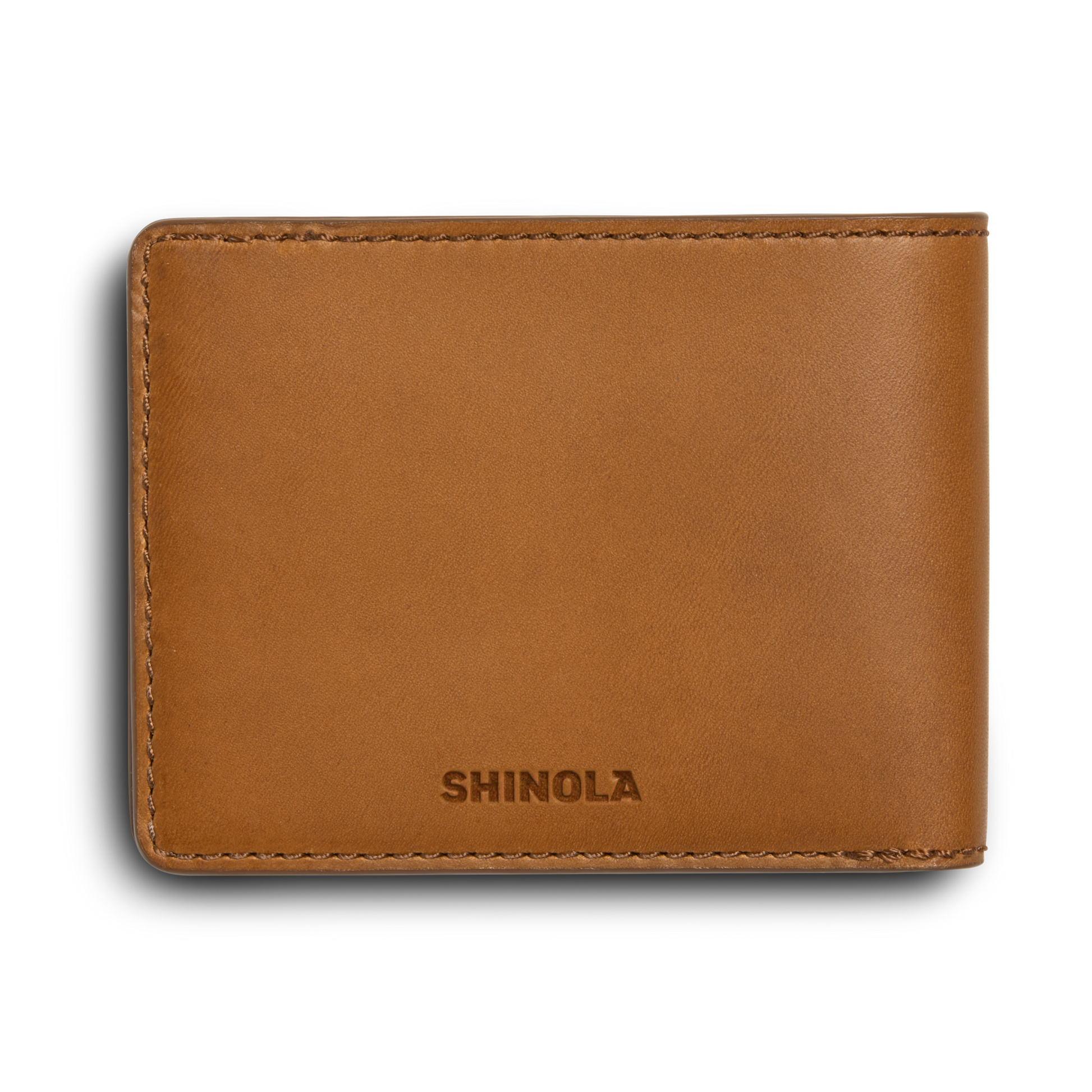 A tan leather Slim Bifold Wallet by Shinola, shown closed with the Shinola logo embossed on the front against a white background.
