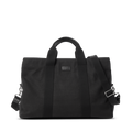 The Shinola Runwell Canvas Duffle Bag - Black features two short handles, a detachable adjustable shoulder strap, and metal hardware—a stylish TSA carry-on or travel duffle, shown against a plain white background.