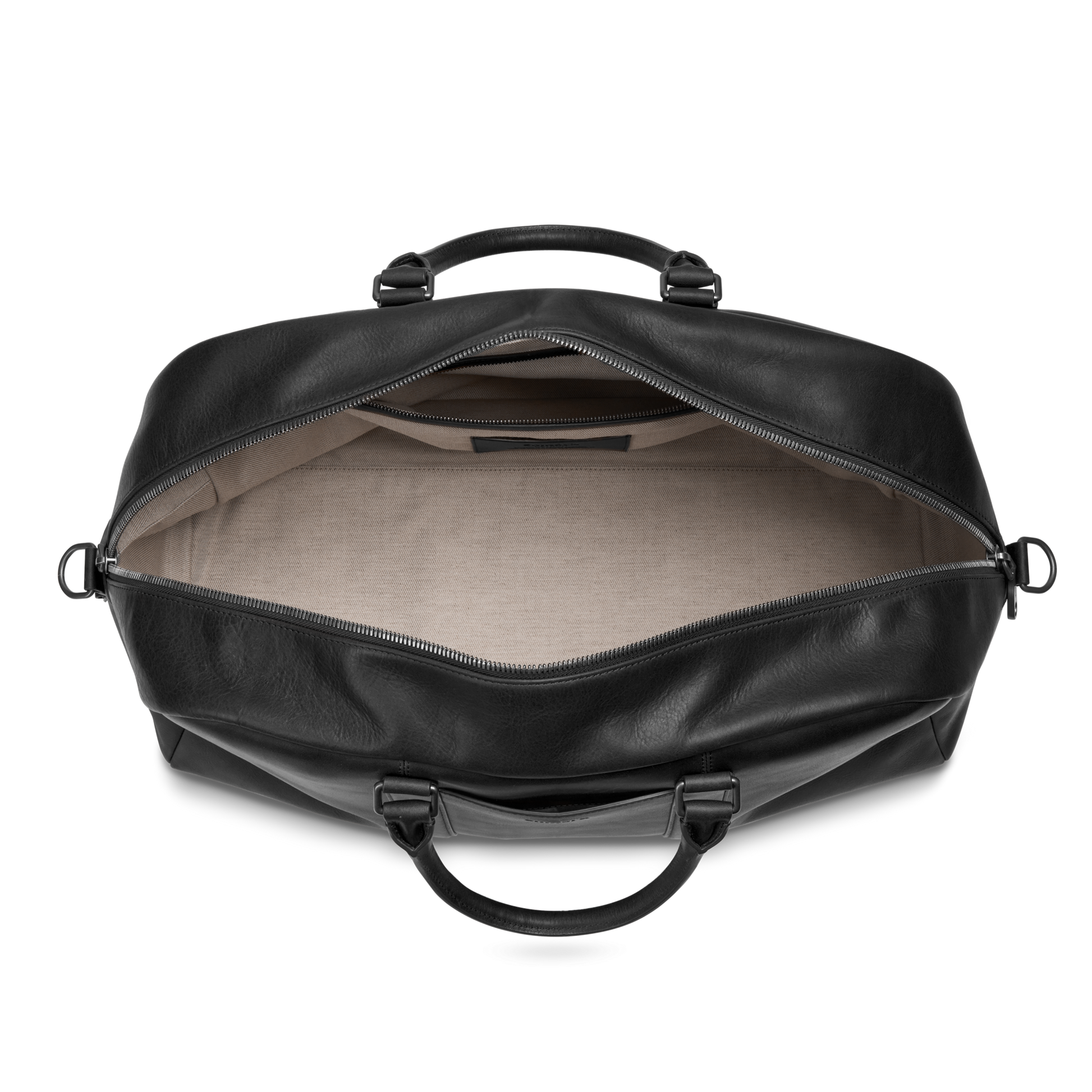 The Shinola Runwell Duffle Bag - Black, crafted from premium Navigator leather with silver hardware, features a beige fabric-lined interior and small inner pocket, shown with its zipper open to reveal the spacious carry-on space.