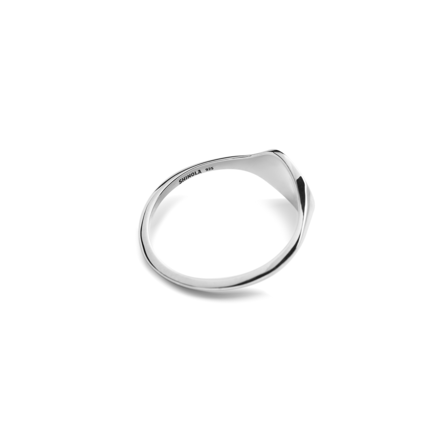 The Shinola Petite Round Signet Ring in polished sterling silver features a smooth, asymmetrical design with subtle engraved text inside the band, shown on a plain white background.