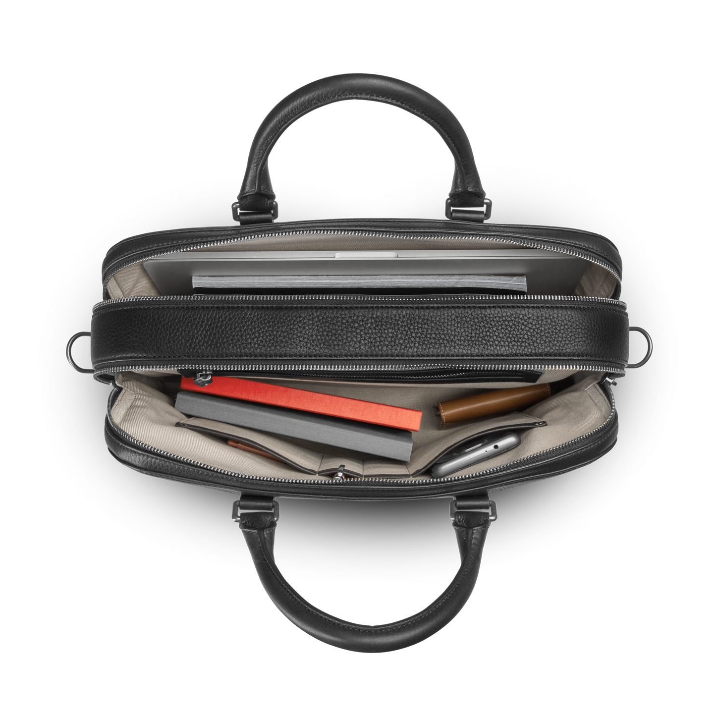 Top view of an open Double Zip Briefcase - Black by Shinola, displaying a laptop, notebooks, smartphone, and writing utensils neatly arranged in black compartments plus an extra compartment for added storage.