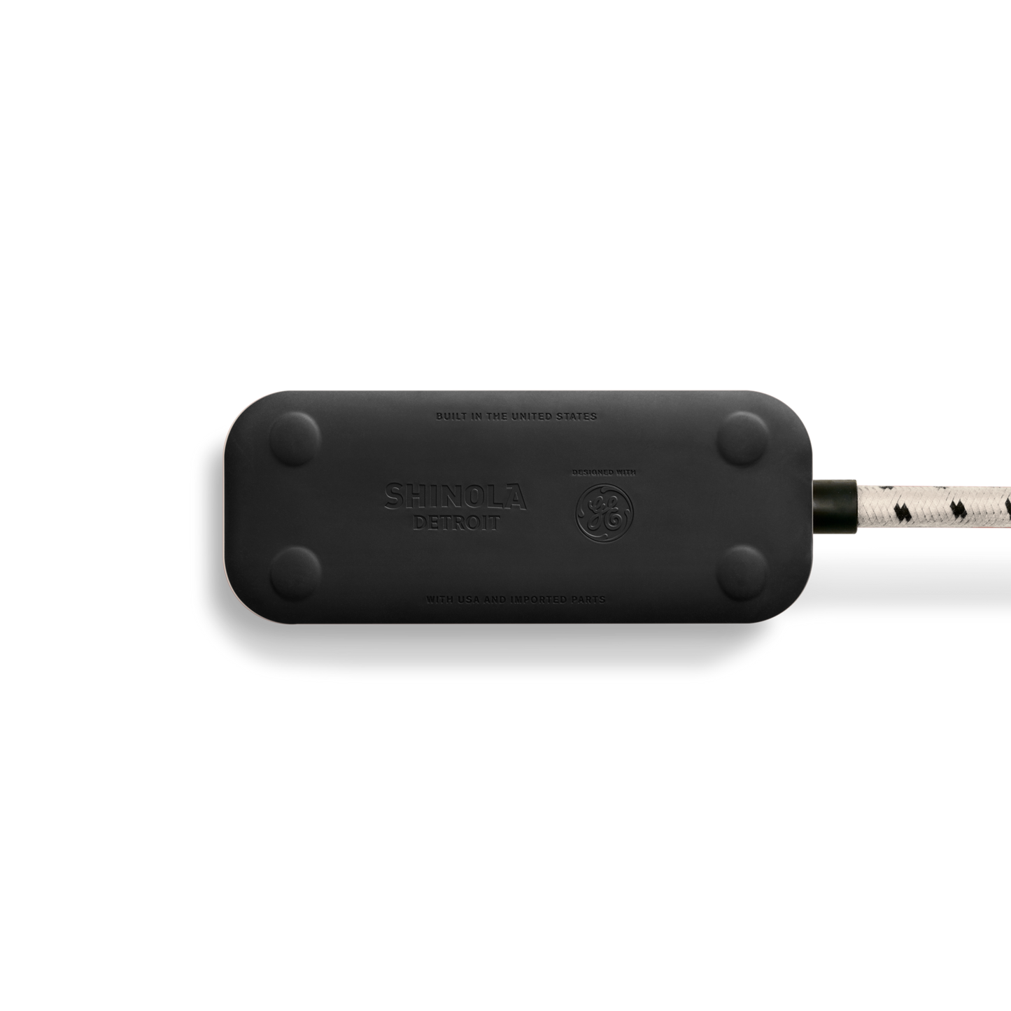 A cream Shinola 2 Port Power Supply with rounded edges, four screw caps, visible branding, a white braided extension cord with black accents, and quick-charging USB-A and USB-C ports is shown against a plain white background.