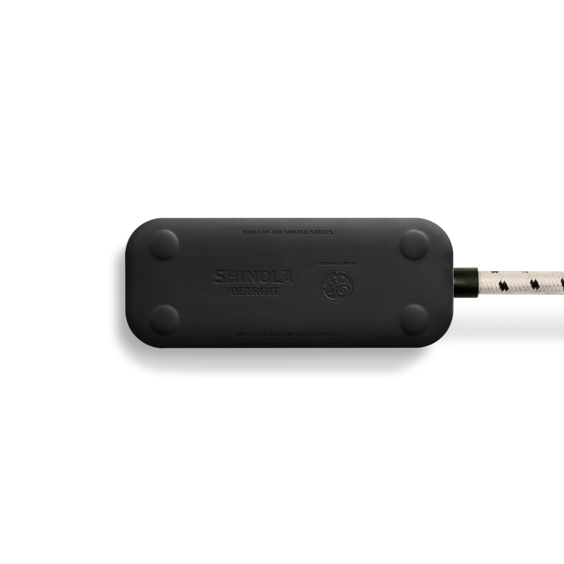 A cream Shinola 2 Port Power Supply with rounded edges, four screw caps, visible branding, a white braided extension cord with black accents, and quick-charging USB-A and USB-C ports is shown against a plain white background.
