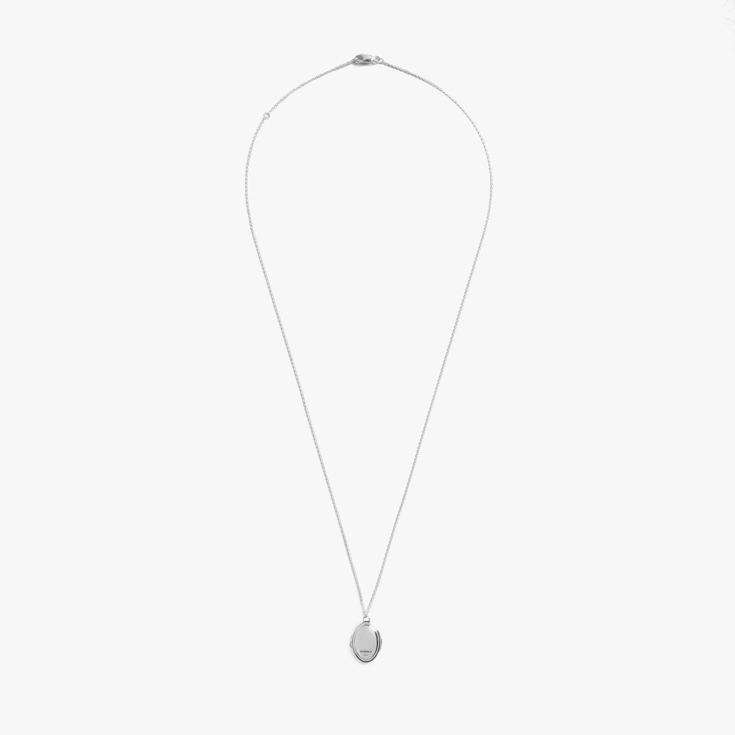 The Shinola Heirloom Petite Locket Necklace in sterling silver features a fine chain and an engravable oval pendant, shown against a plain white background.