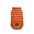 The Shinola Reversible Puffer Dog Coat in Orange/Black is a quilted, warm jacket for dogs, shown flat on a white background with a small black label near the hem.