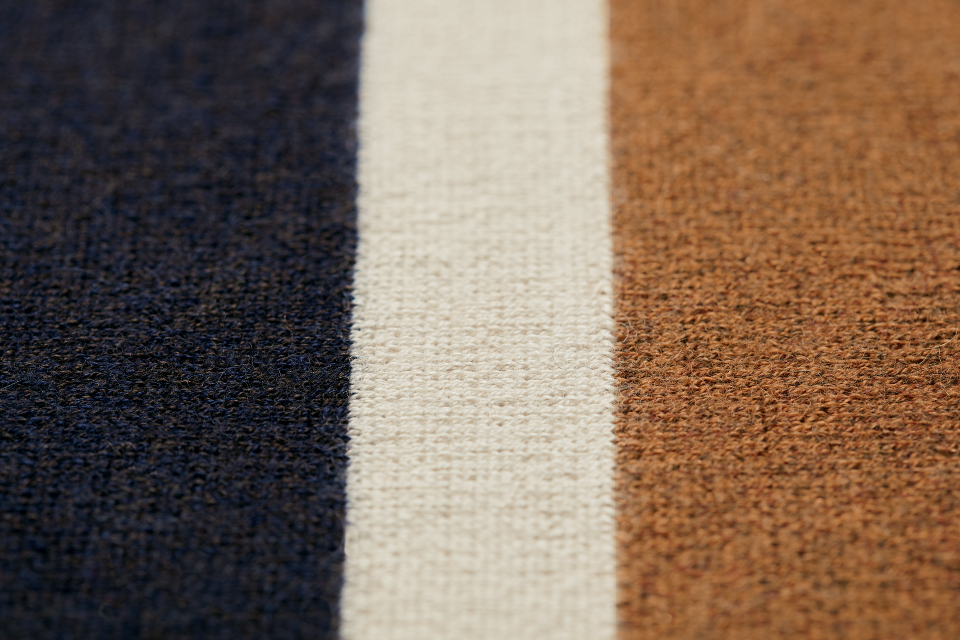 Close-up of the soft, textured surface of the Shinola Alpaca Throw Blanket in Pink/Beige—features woven detail and luxurious feel, reminiscent of sustainable Royal Baby Alpaca.