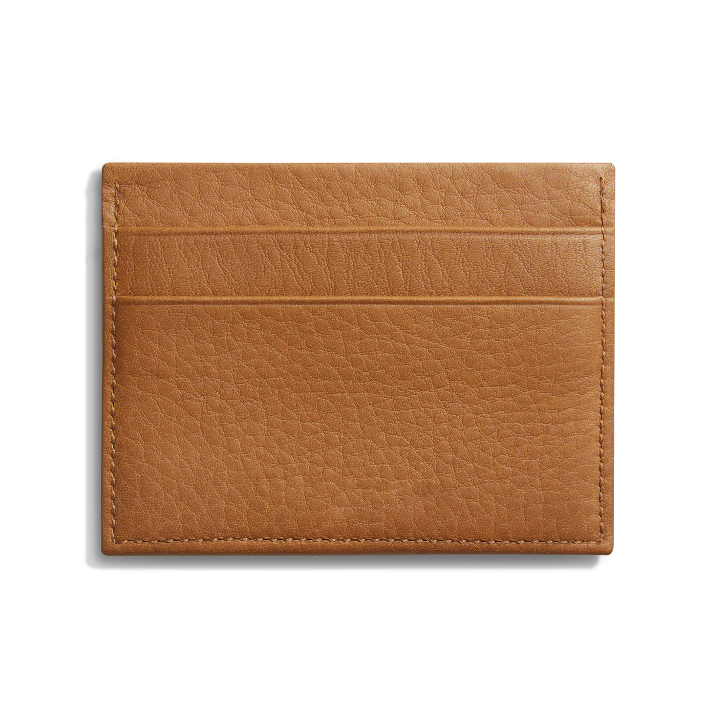 The Shinola 5 Pocket Card Holder in tan leather offers a pebbled finish, two horizontal card slots on one side, and a slim design—ideal as a daily wallet for carrying essentials. Shown against a plain white background.