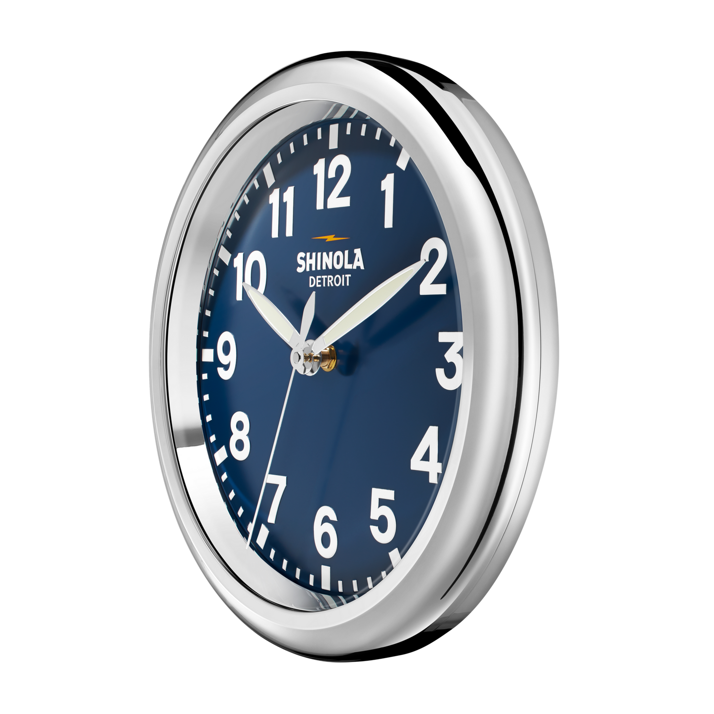 The Shinola 14" Runwell Clock - Navy features a round design with a shiny silver frame, matte navy dial, and white numbers and hands. The clock displays about 1:10 and showcases the signature Shinola brand style.