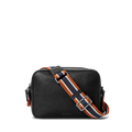 The Shinola Camera Crossbody Bag - Black is a small leather bag with a textured finish and a wide, adjustable orange, navy, and white striped woven strap, shown against a plain white background.