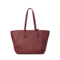 The Shinola Runabout Tote Bag - Ruby is a large, deep red pebbled leather tote with two long handles, a textured surface, and minimalistic design. Lightweight and practical, it includes an interior zipper pouch. Shown on a plain white background.