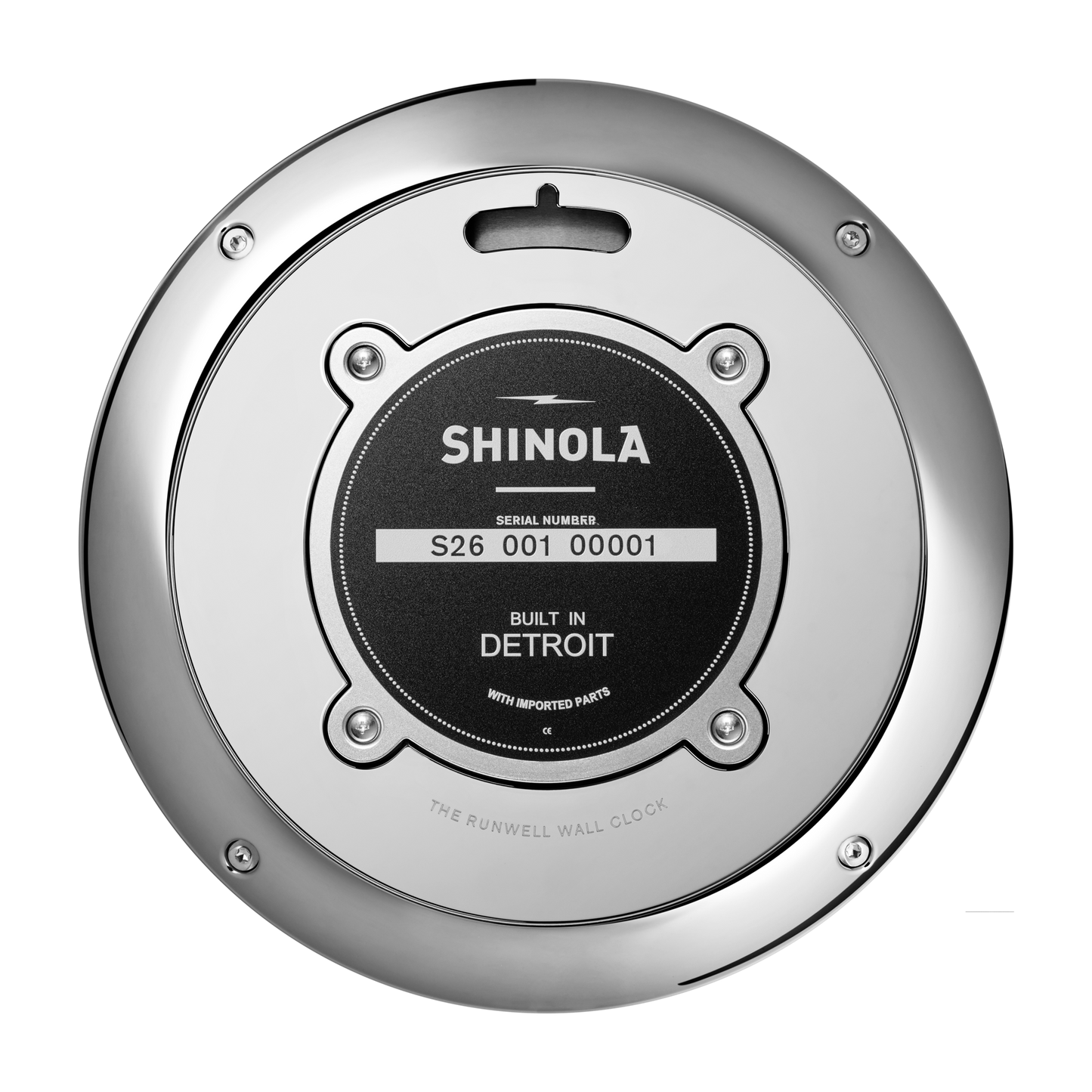 Close-up of the back of a Shinola 14" Runwell Clock - Navy, showing a serial number label stating "Built in Detroit with Imported Parts." The clock features a metallic outer rim with visible screws and a matte midnight blue dial.