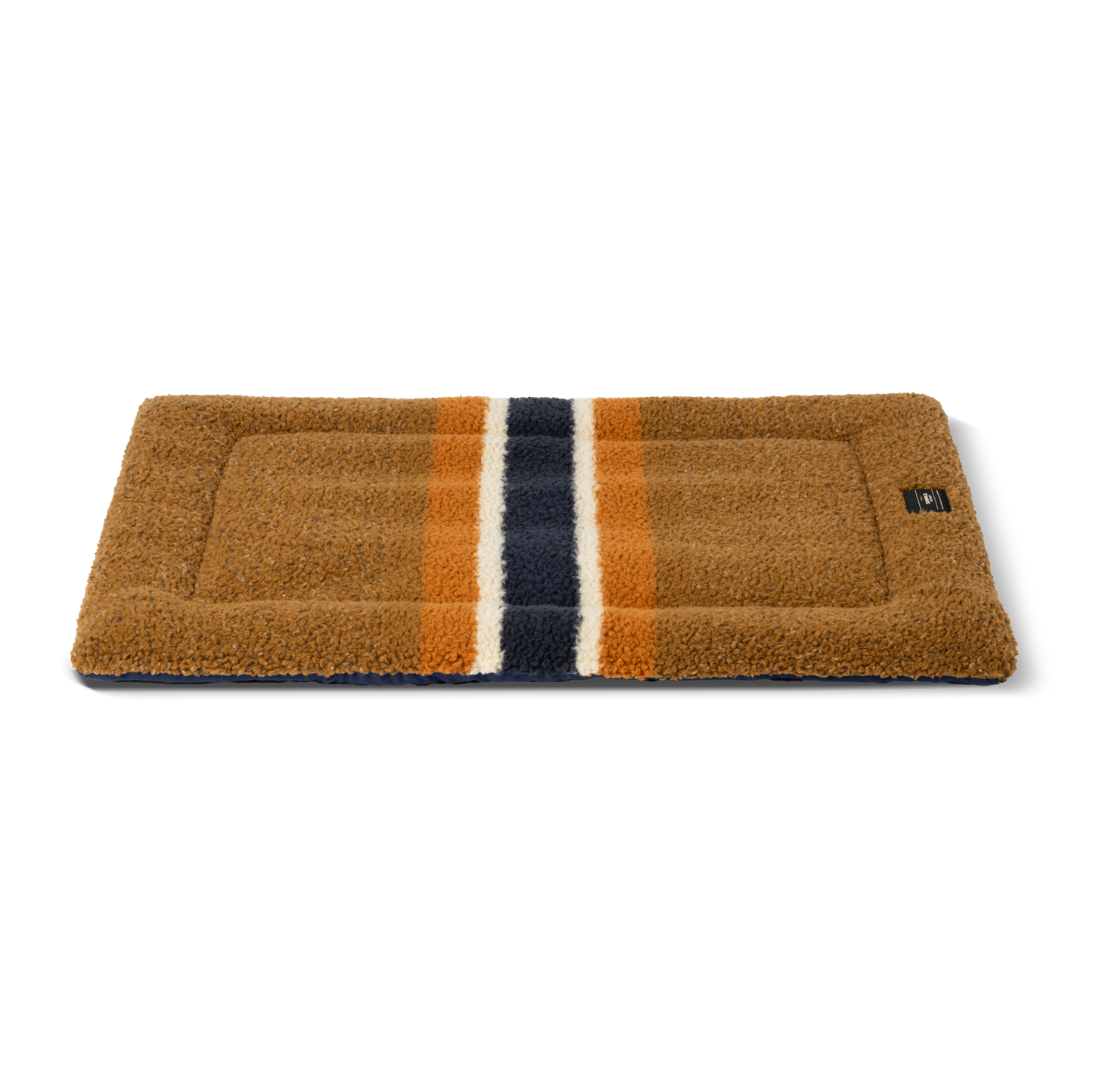The Shinola Crate Comfort Mat - Stripe Brown features a rectangular brown design with three vertical stripes (navy blue, white, orange) at the center. It's machine washable, perfect as a dog bed or a cozy crate cushion.