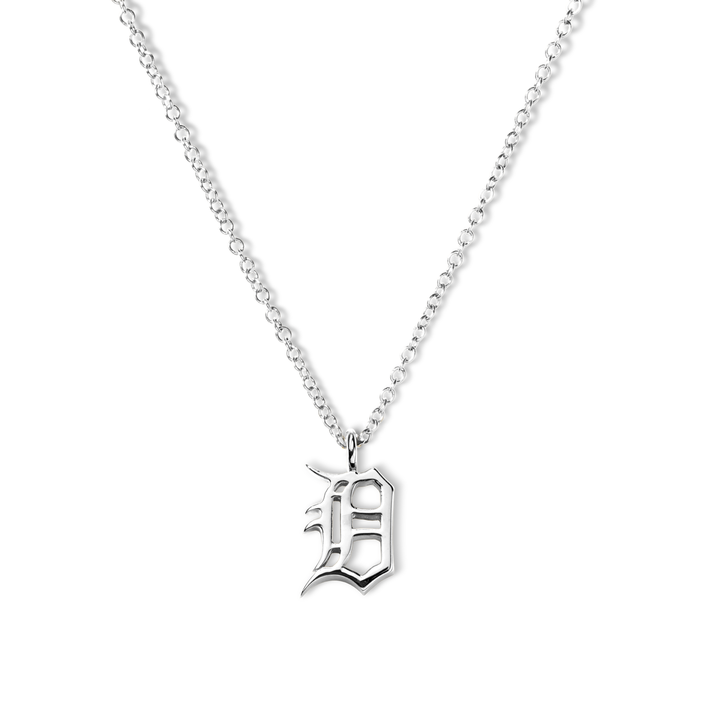 The Shinola Detroit "D" Charm Necklace in sterling silver features a thin chain and an ornate gothic "D" pendant, elegantly displayed against a white background—a stylish nod to classic Detroit jewelry.