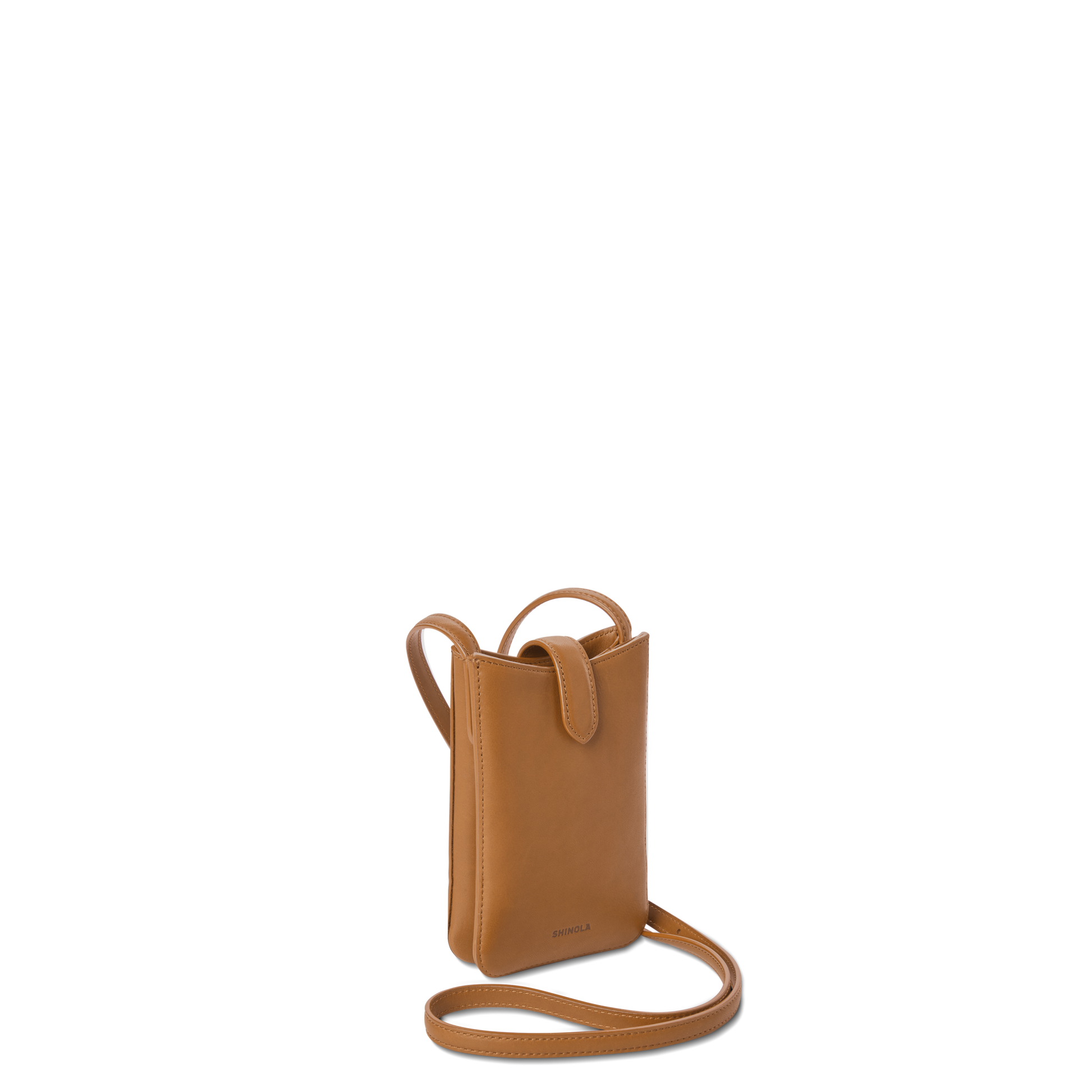 The Shinola Bixby Phone Crossbody in tan natural leather, featuring a long strap and flap closure, stands upright against a plain white background—perfect for those who travel light.