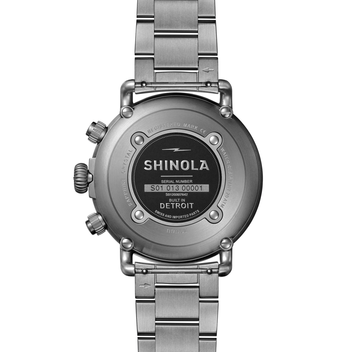 The back of the 42mm Shinola Runwell Chronograph West Wind Watch features engraved details, visible buttons, a metal link band, and “Built in Detroit” with the serial number and brand name. Includes an additional blue strap in this gift set.