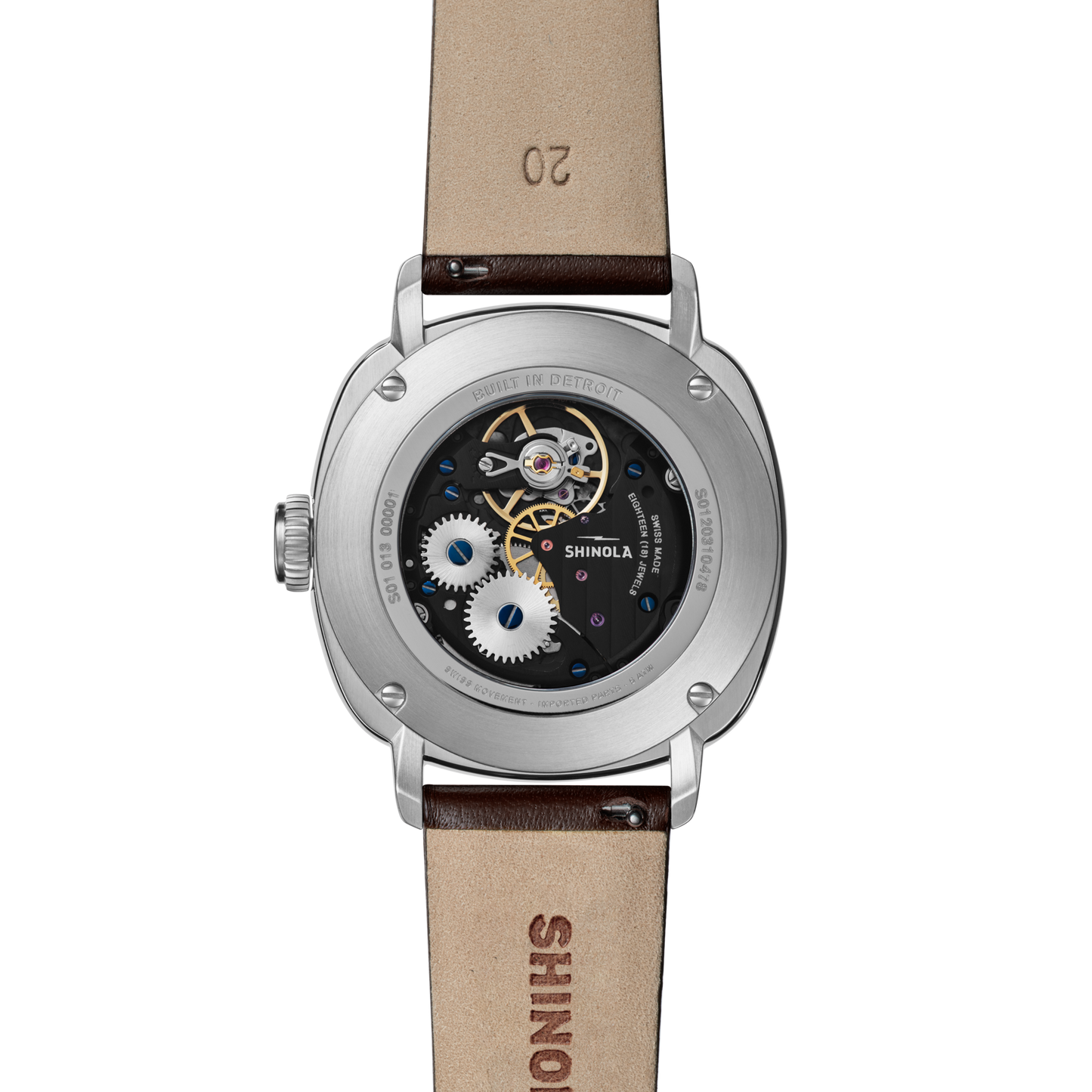 Back view of the Shinola Mechanic Watch - Alabaster displays its intricate movement and visible gears through an exhibition case back, complemented by a brown leather strap embossed with SHINOLA.