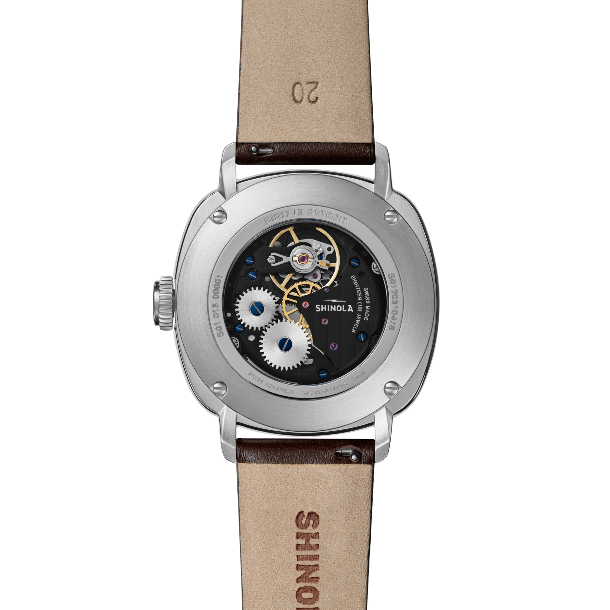 Back view of the Shinola Mechanic Watch - Alabaster displays its intricate movement and visible gears through an exhibition case back, complemented by a brown leather strap embossed with SHINOLA.
