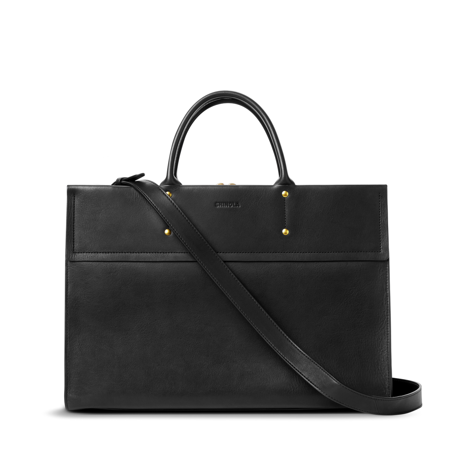 The Shinola Day Satchel - Black is a structured, rectangular bag in sleek black leather with gold hardware, two short handles, and a long adjustable shoulder strap—perfect as an on-the-go accessory against a white background.