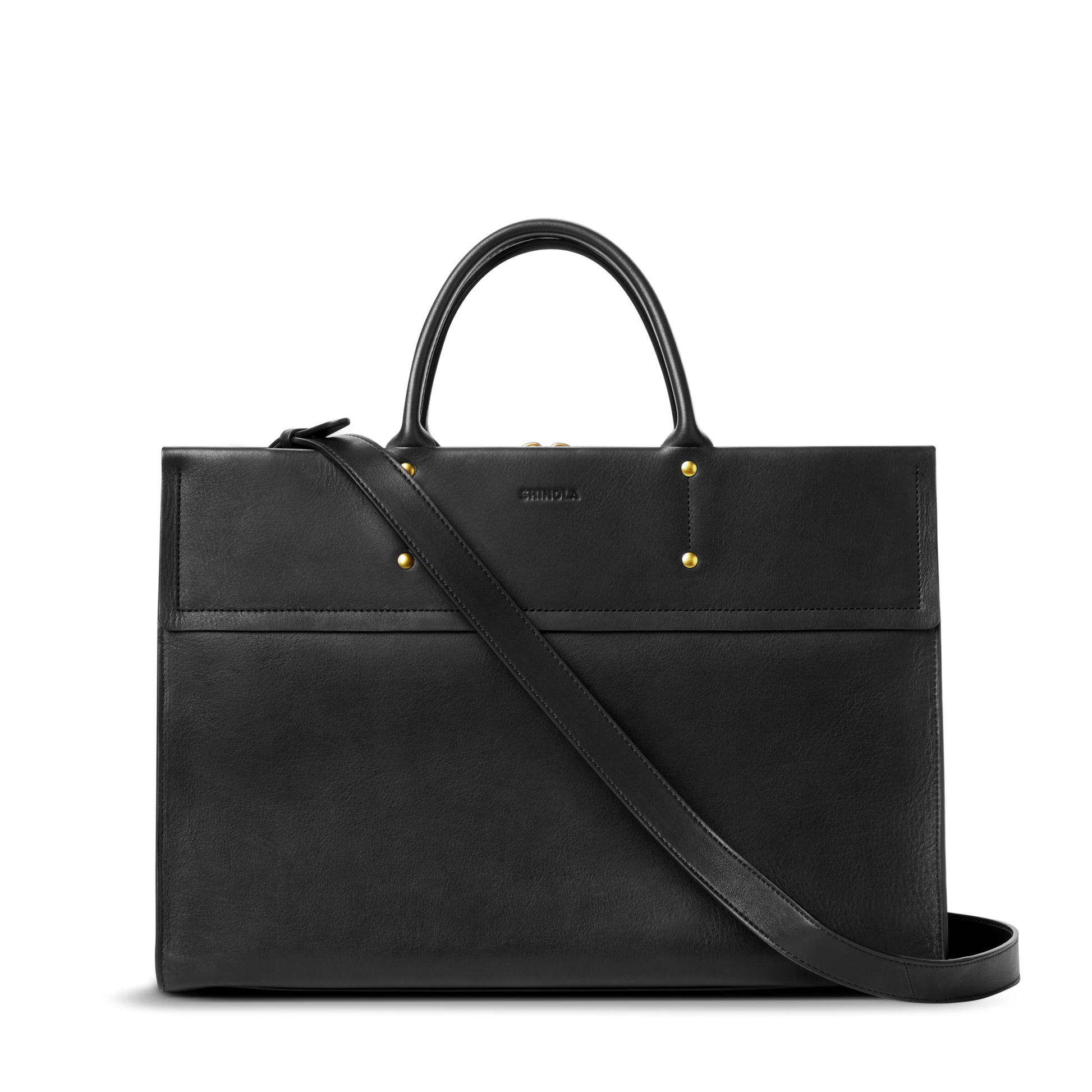 The Shinola Day Satchel - Black is a structured, rectangular bag in sleek black leather with gold hardware, two short handles, and a long adjustable shoulder strap—perfect as an on-the-go accessory against a white background.