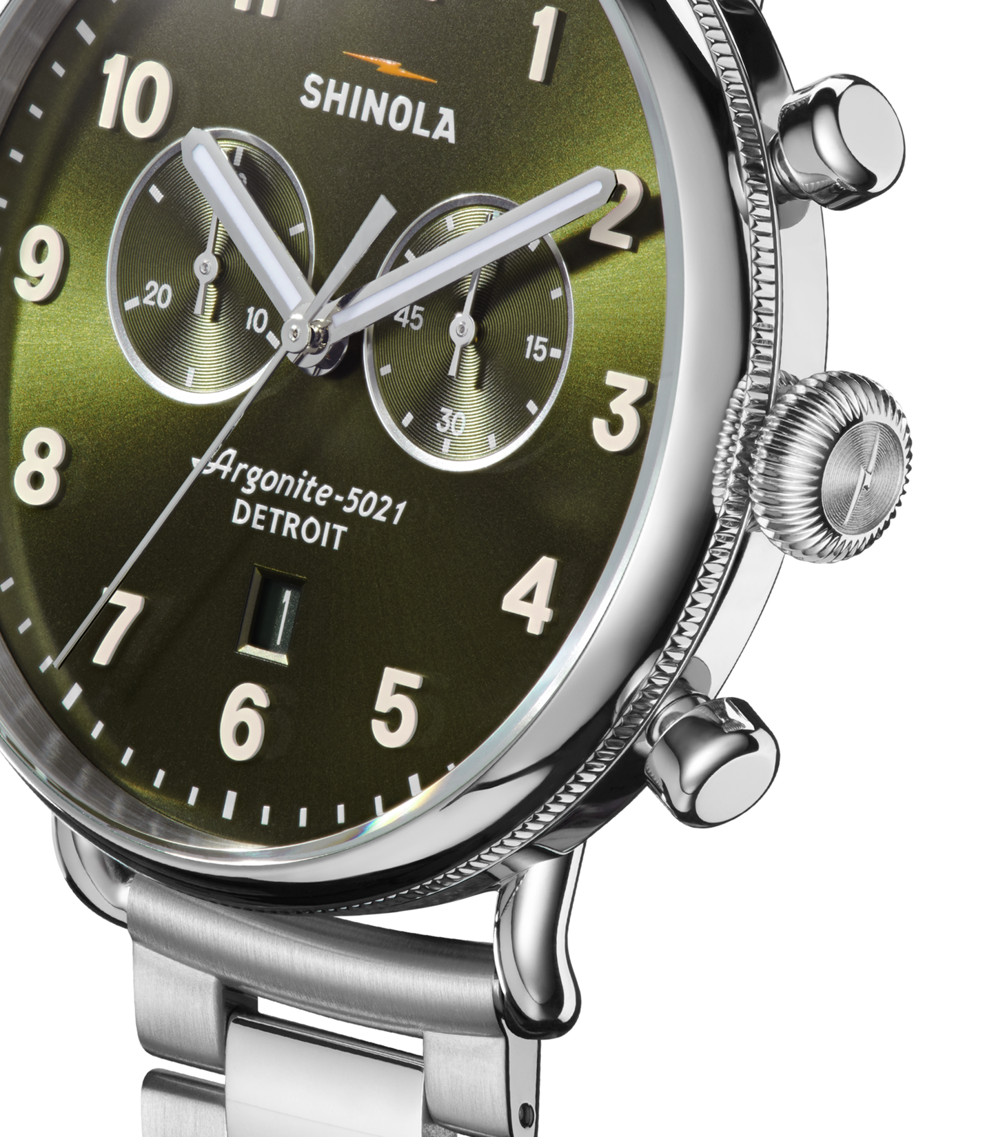 Close-up of the Shinola Canfield Chronograph Watch - Dark Olive, featuring a stainless steel case and band, metallic green face with dark olive accents, silver hour markers, two subdials, and time set to 10:09:36.