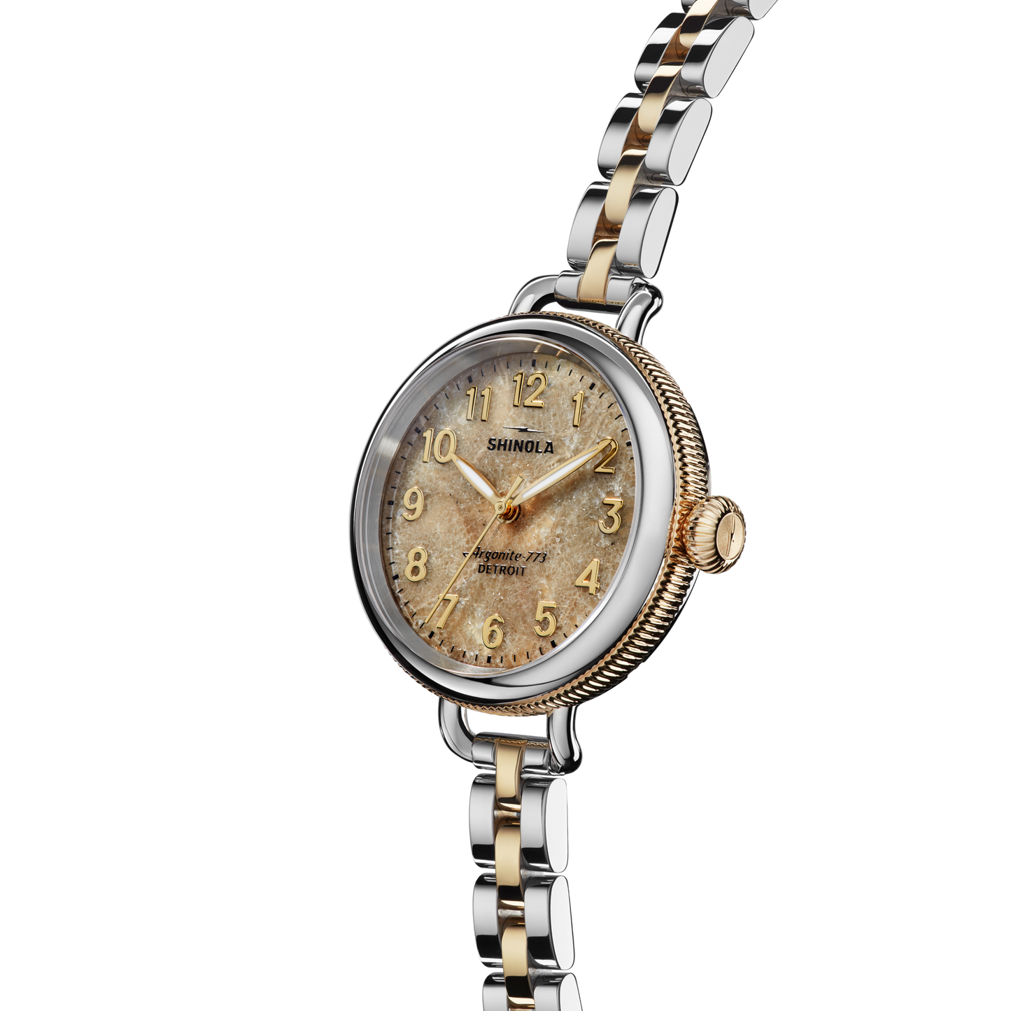 The Shinola Birdy Watch - Petoskey features a round, textured beige dial with gold-tone numerals and hands, a fluted bezel, and a two-tone gold and stainless steel bracelet. The Shinola brand name is visible on the Detroit-assembled watch face.
