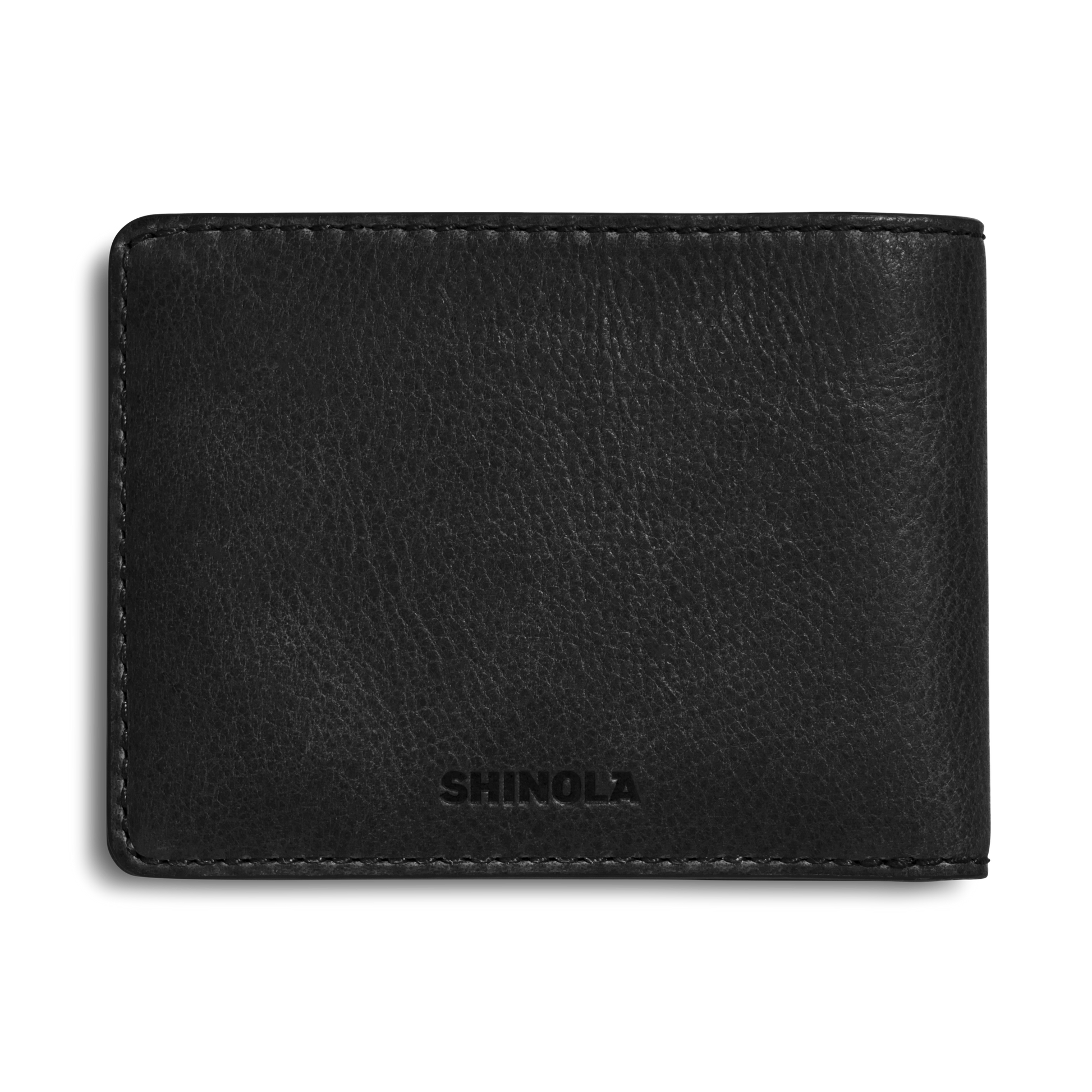 The Shinola Slim Bifold Wallet - Black features premium leather, visible edge stitching, and an embossed logo on the lower front. This refined credit card holder is shown against a plain white background.
