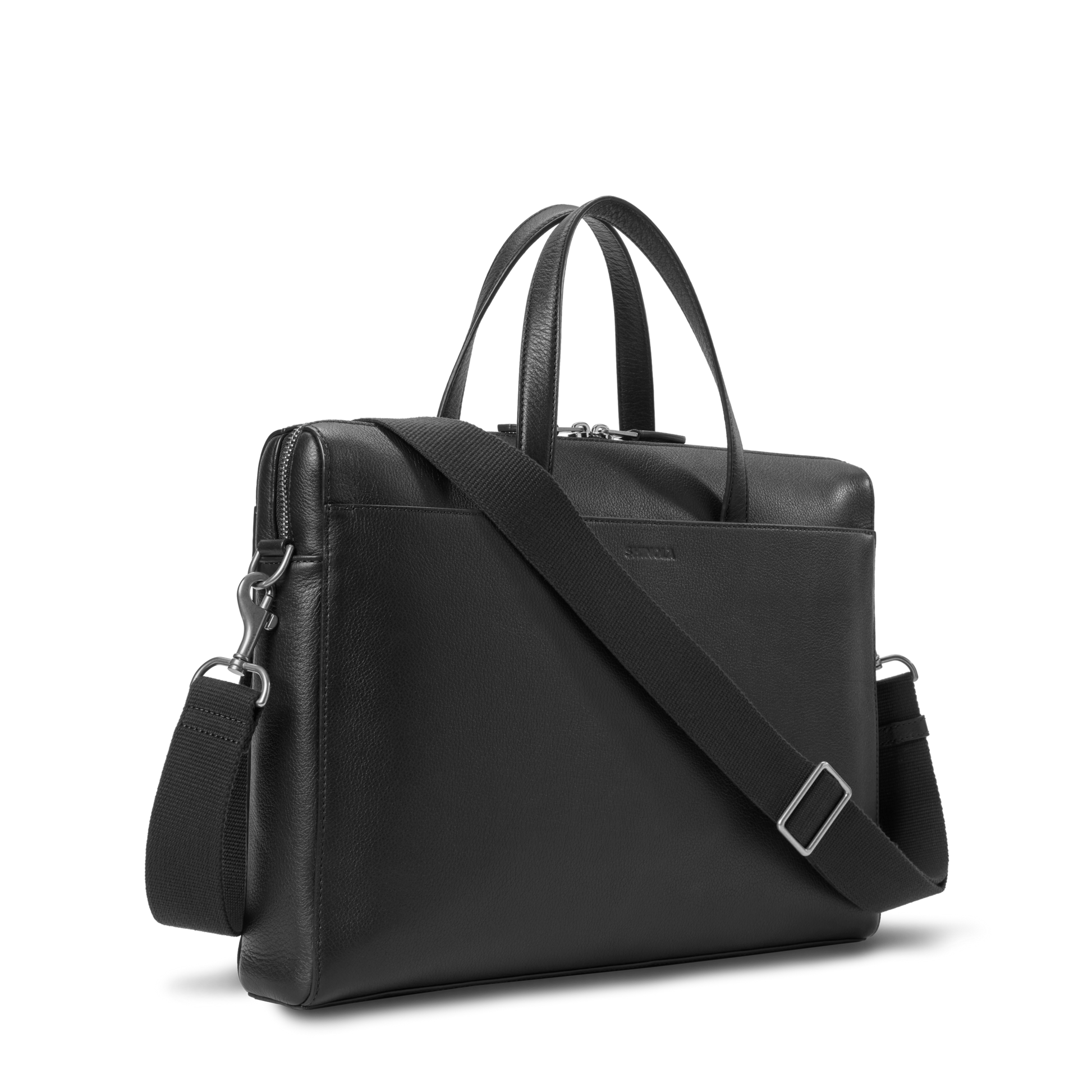 The Shinola Canfield Briefcase in black pebbled leather is designed for modern commuters, with a detachable, adjustable shoulder strap and two short handles, shown on a white background.