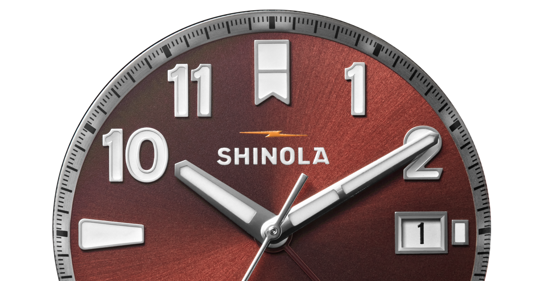 Close-up of the Shinola Monster GMT Automatic Watch - Whiskey, featuring a brown metallic face, silver hands, bold white numerals, a date window showing "1," and a yellow lightning bolt—an ideal travel companion with automatic movement.