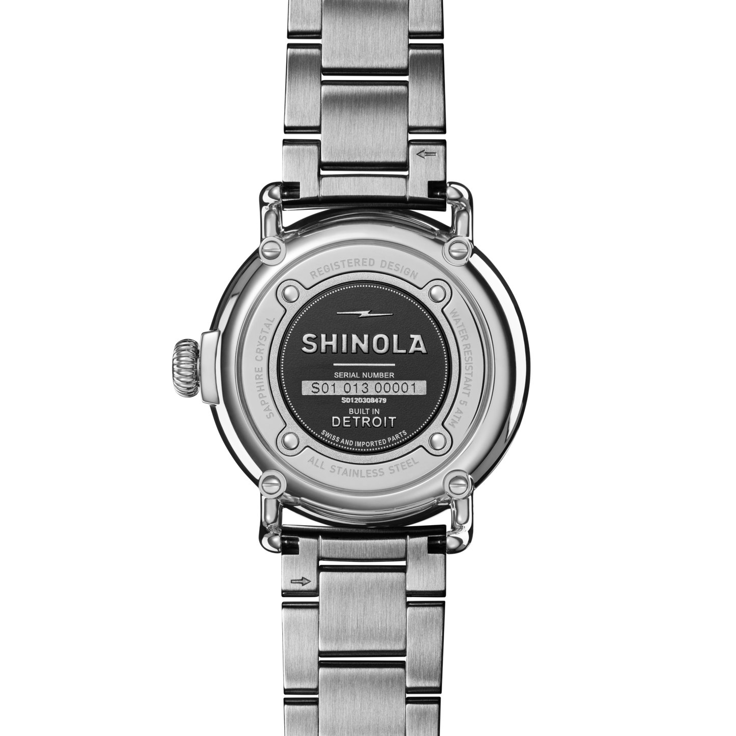 The back of a Shinola Runwell Watch - Cadet Blue with stainless-steel bracelet features engraved details like the brand name, serial number, "Built in Detroit" text, and is secured by four screws on its round case back.