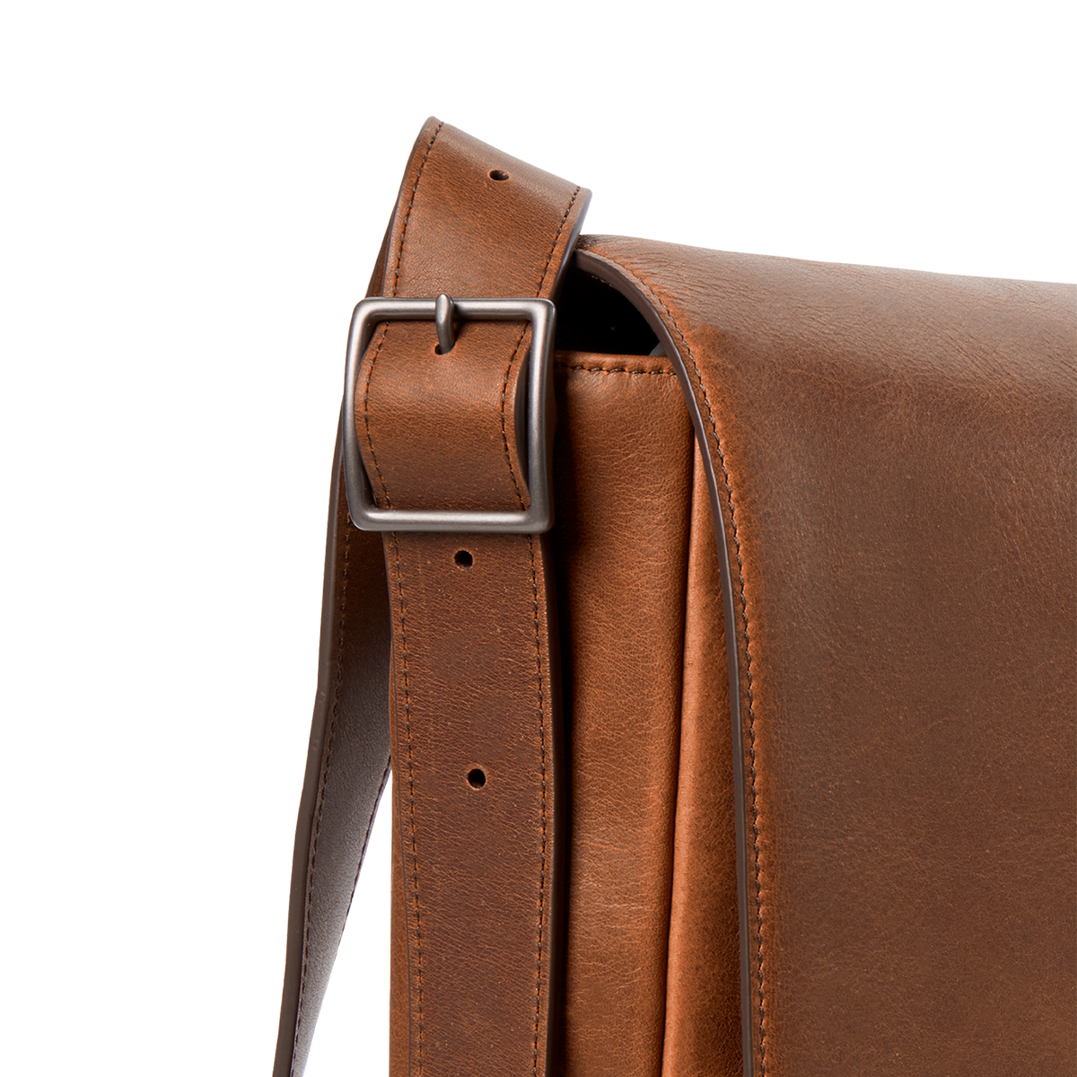 Close-up of the Shinola Runwell Messenger Bag in medium brown leather, featuring a metal buckle on the adjustable crossbody strap, set against a plain white background.