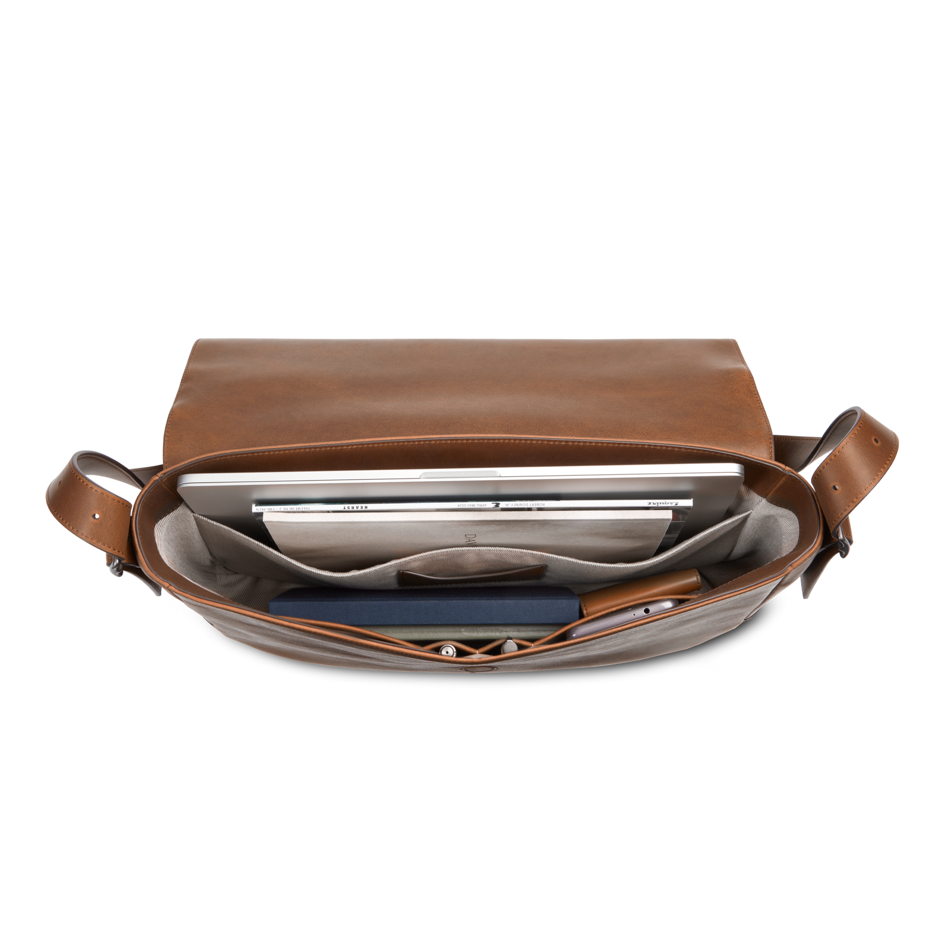 The Shinola Runwell Messenger Bag in medium brown, shown from above against a white background, displays organized compartments for a laptop, notebook, documents, and small items. It features a sturdy crossbody strap.