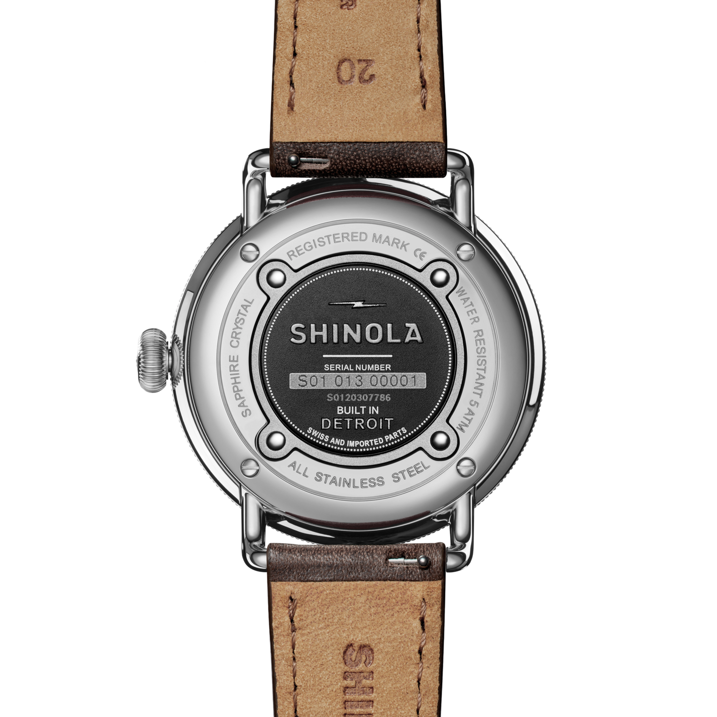 The back of the Shinola Canfield Watch - Dark Olive with a leather strap displays engraved details like the brand name, “Built in Detroit,” serial number, and specs such as stainless steel case and water resistance.