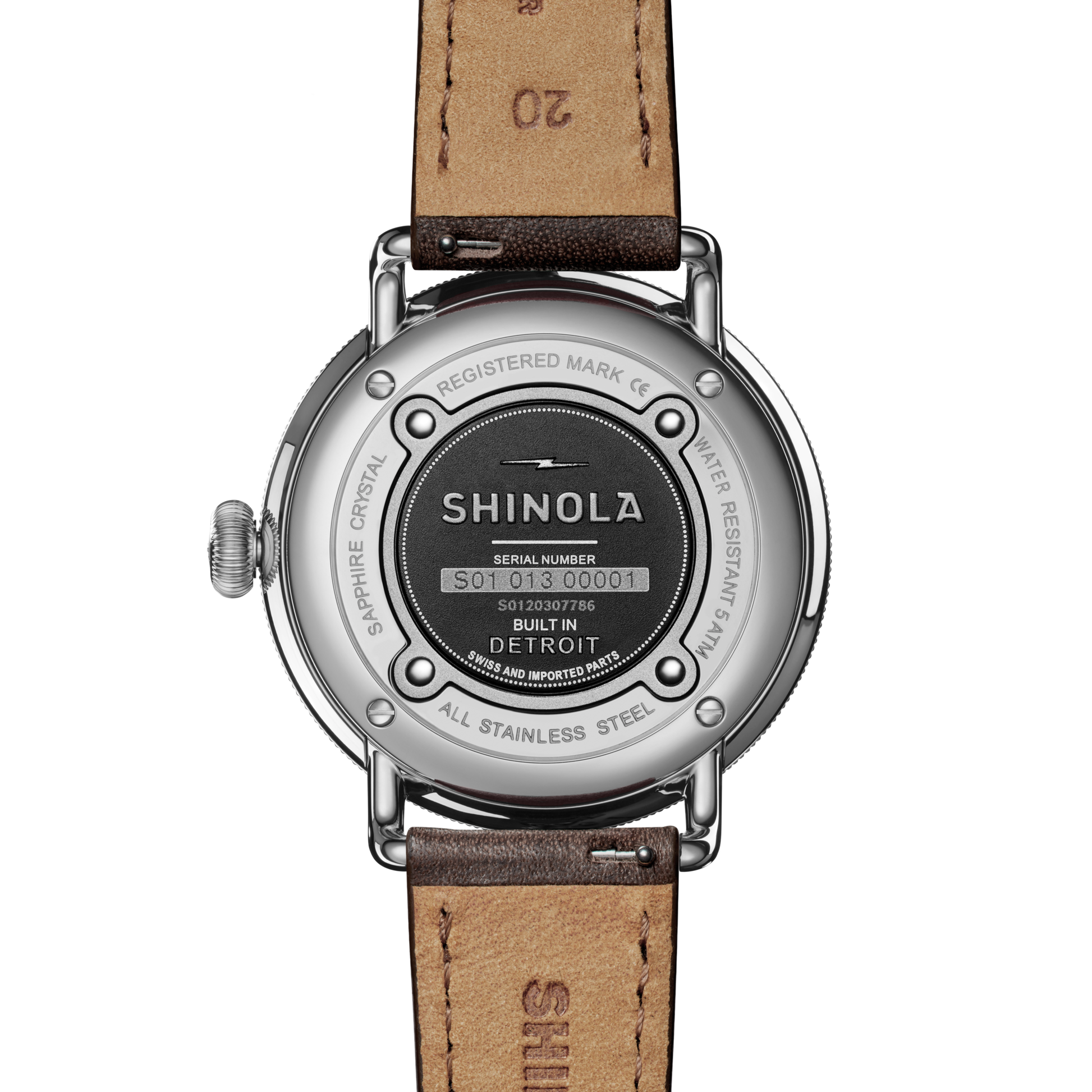 The back of the Shinola Canfield Watch - Dark Olive with a leather strap displays engraved details like the brand name, “Built in Detroit,” serial number, and specs such as stainless steel case and water resistance.