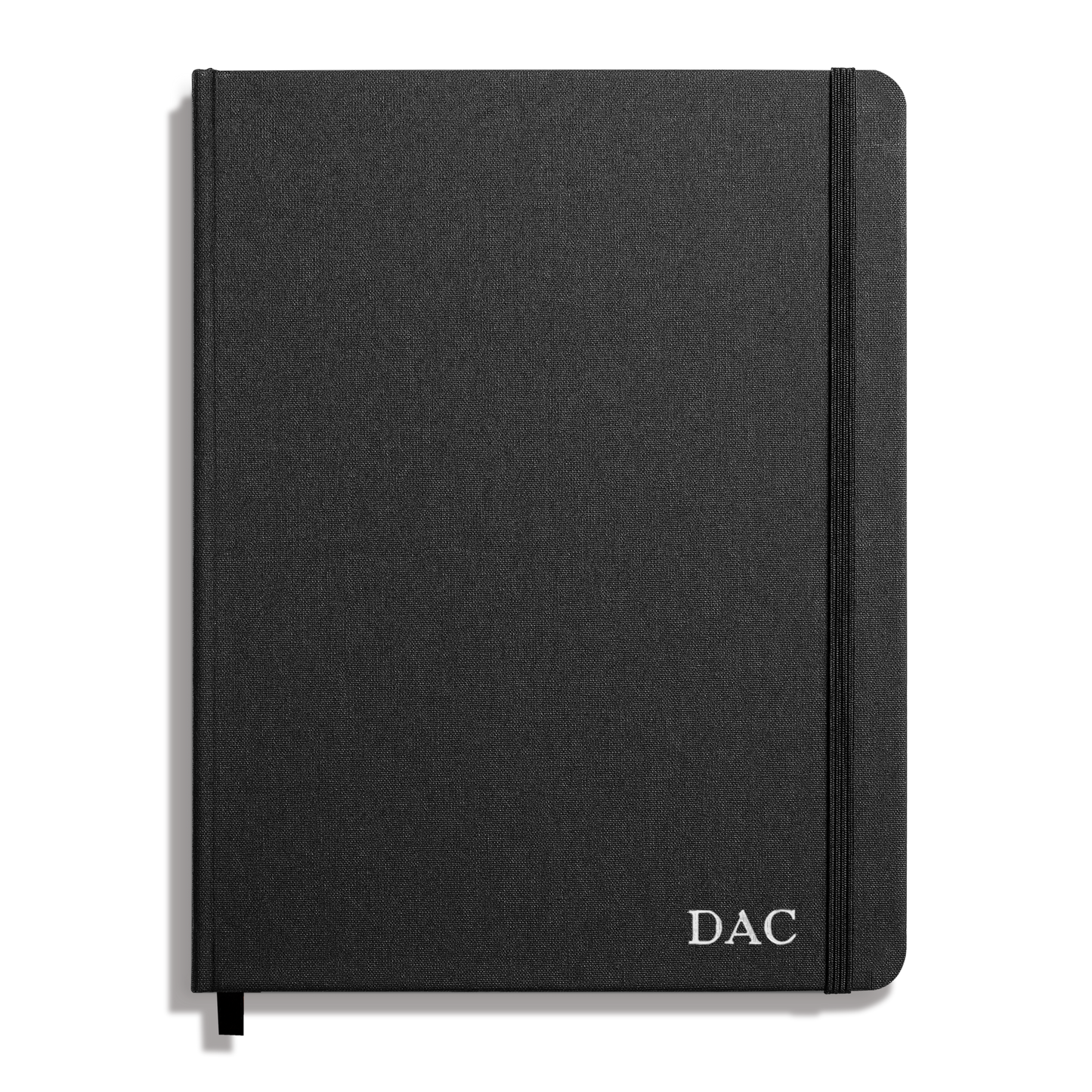 The Shinola Large Hard Plain Journal in black features a durable linen cover, elastic band closure, DAC initials in white on the bottom right, and acid-free paper for long-lasting quality.