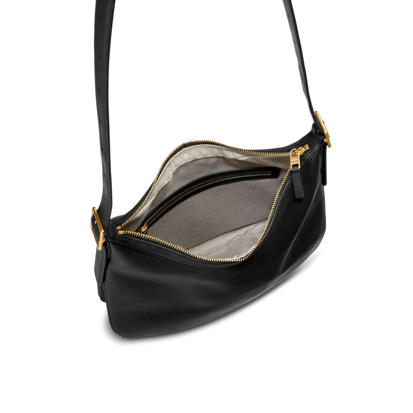 The Shinola Medium Bixby Crossbody in black natural leather features gold hardware, a light beige fabric lining, and an interior zip pocket—a stylish and versatile accessory for any occasion.