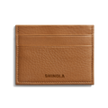 The Shinola 5 Pocket Card Holder - Tan is a compact leather wallet with five slots, visible edge stitching, and the Shinola name embossed on the front, blending style and function in a slim design.