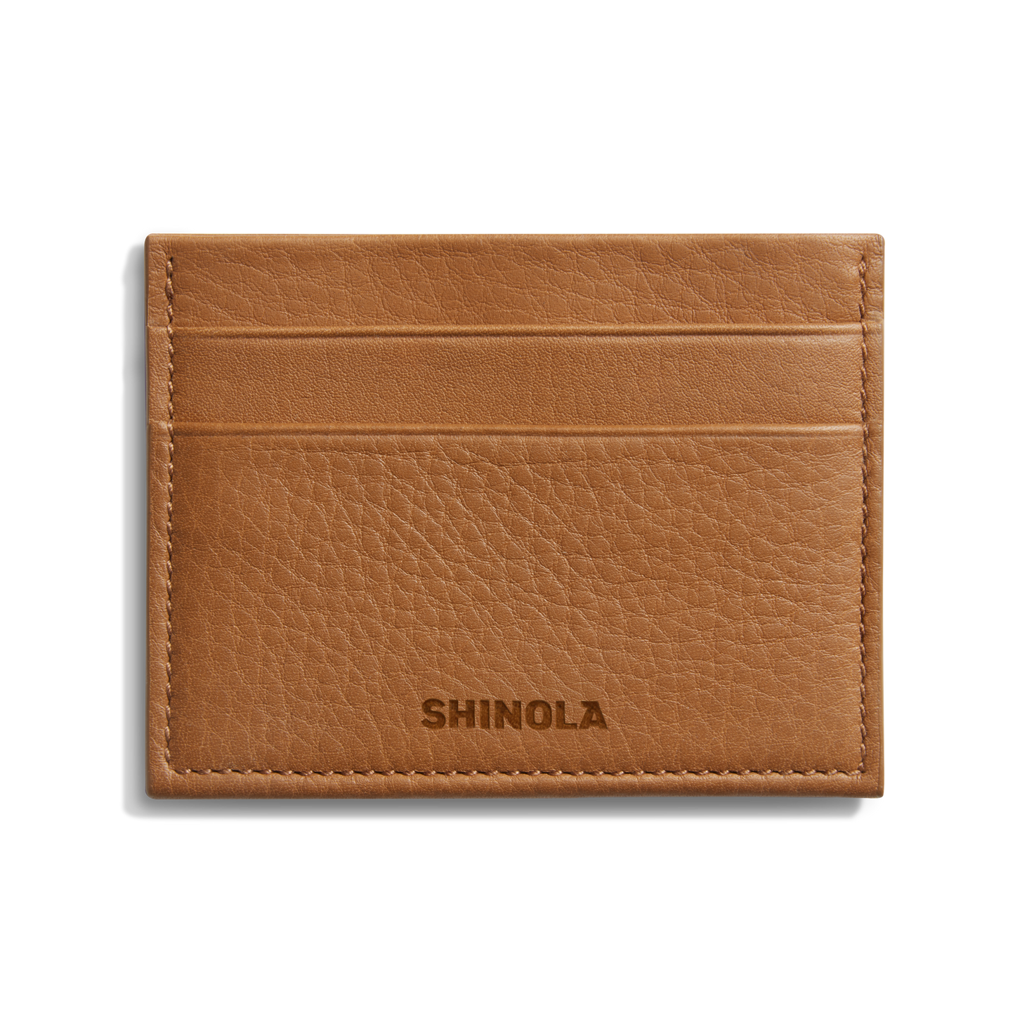 The Shinola 5 Pocket Card Holder - Tan is a compact leather wallet with five slots, visible edge stitching, and the Shinola name embossed on the front, blending style and function in a slim design.