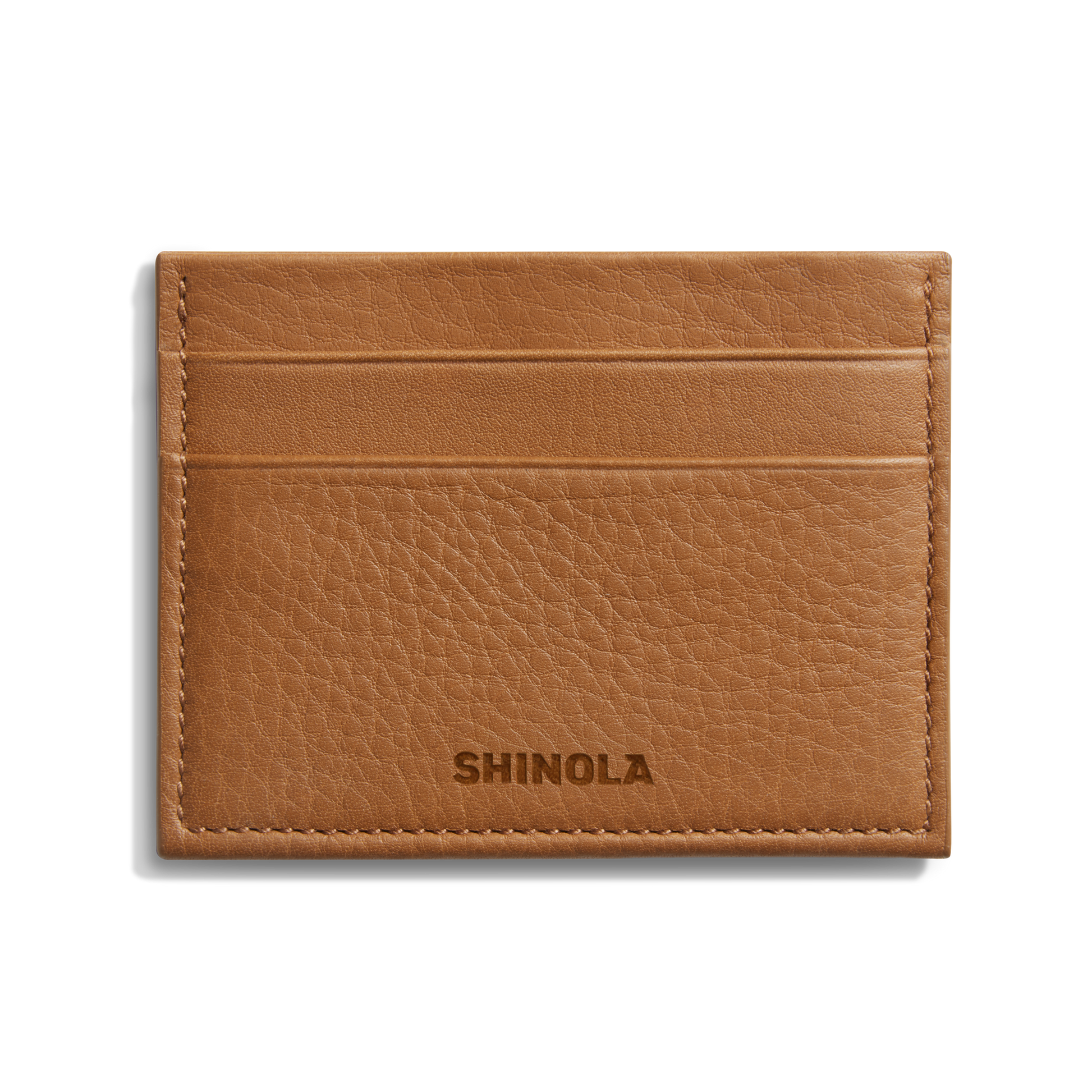 The Shinola 5 Pocket Card Holder - Tan is a compact leather wallet with five slots, visible edge stitching, and the Shinola name embossed on the front, blending style and function in a slim design.