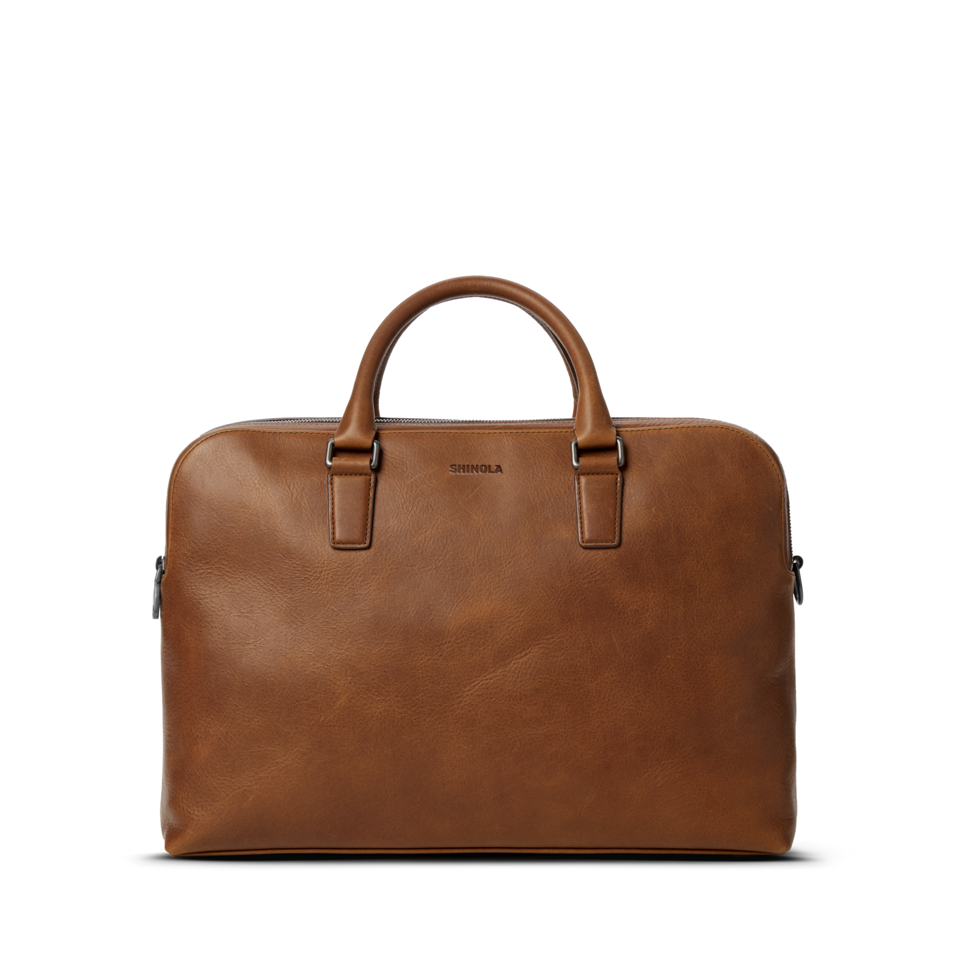The Shinola Double Zip Briefcase in medium brown features premium leather, two handles, a smooth finish, and the Shinola logo embossed near the top center, displayed against a plain white background.