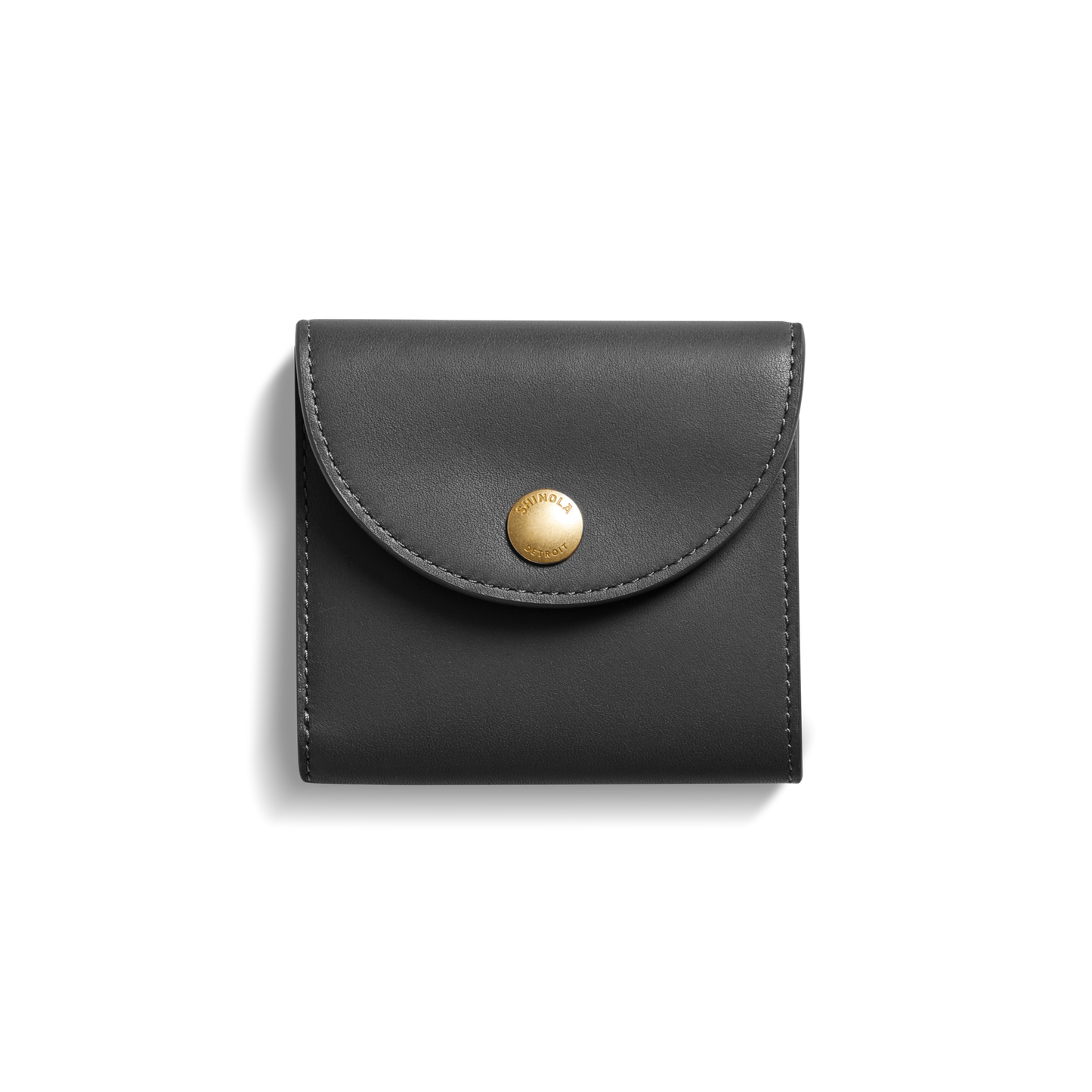 The Shinola Birdy Small Snap Wallet in black leather, featuring a curved flap, card pockets, and a round gold snap button, is centered on a white background.
