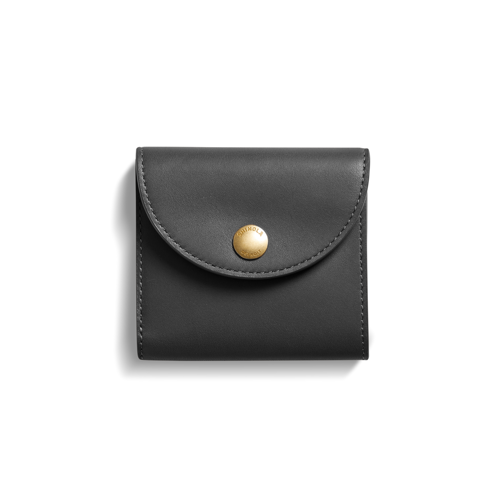 The Shinola Birdy Small Snap Wallet in black leather, featuring a curved flap, card pockets, and a round gold snap button, is centered on a white background.