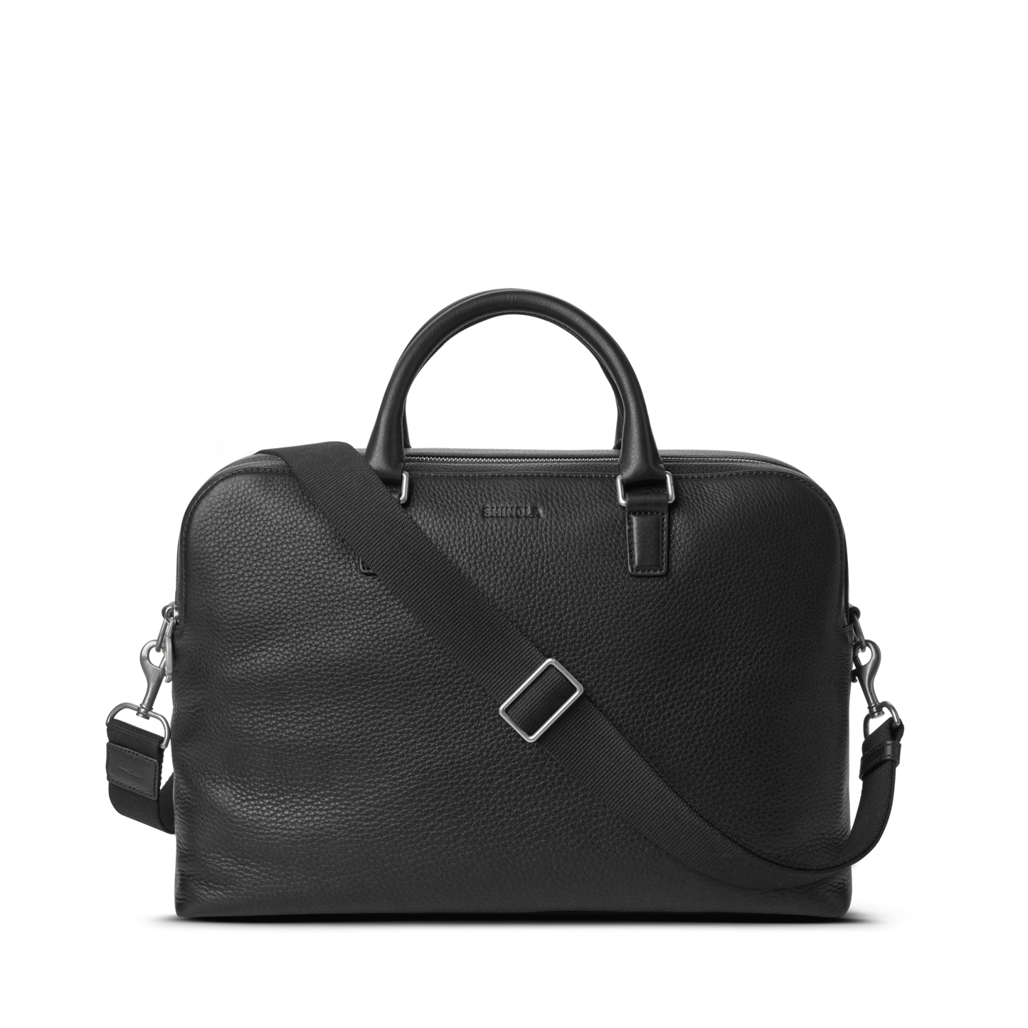 The Shinola Double Zip Briefcase - Black features natural grain leather, two top handles, a detachable shoulder strap, silver hardware, and an extra compartment, shown against a plain white background.