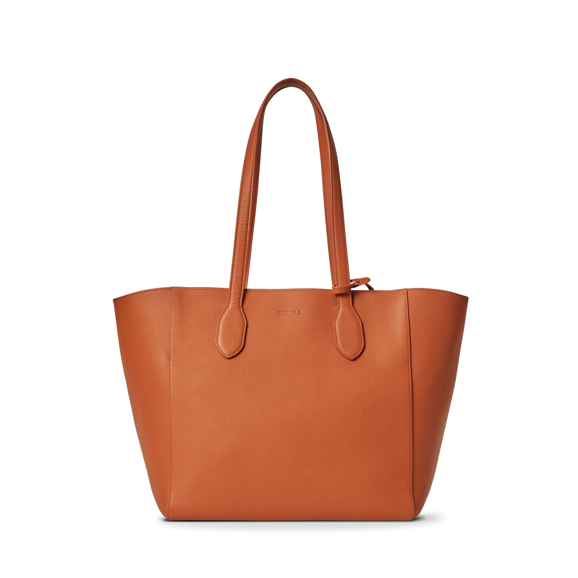 The Shinola Runabout Tote Bag - Rust is crafted from brown pebbled leather, has two straps, an embossed front logo, and includes an interior zipper pouch for convenience.