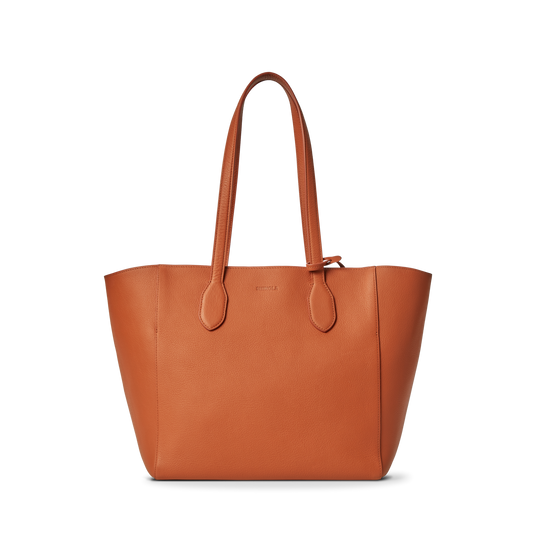 The Shinola Runabout Tote Bag - Rust is crafted from brown pebbled leather, has two straps, an embossed front logo, and includes an interior zipper pouch for convenience.