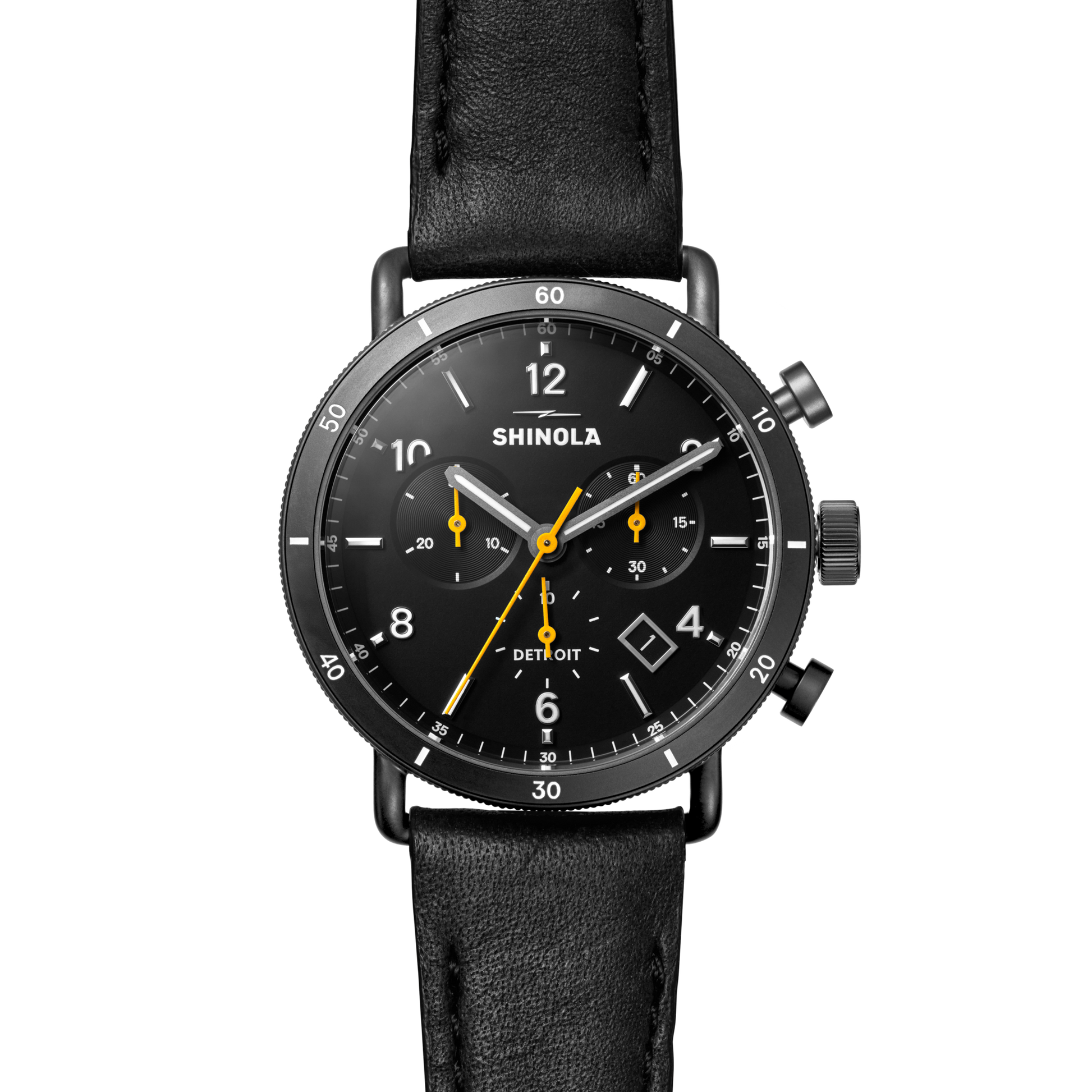 The Shinola Canfield Sport Chronograph Watch features a black leather strap, black dial with white numerals, yellow hands, and is shown against a light gray background.