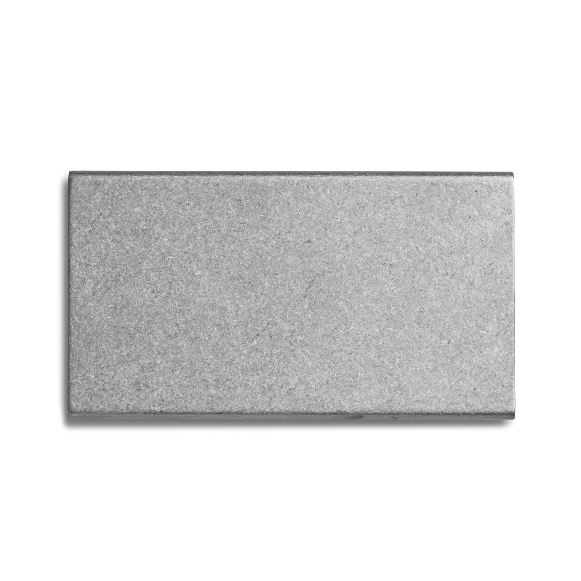 A rectangular, gray cement brick with a smooth surface, seen from above on a white background—ideal as a unique base for the Shinola Aluminum Matchbox Set.