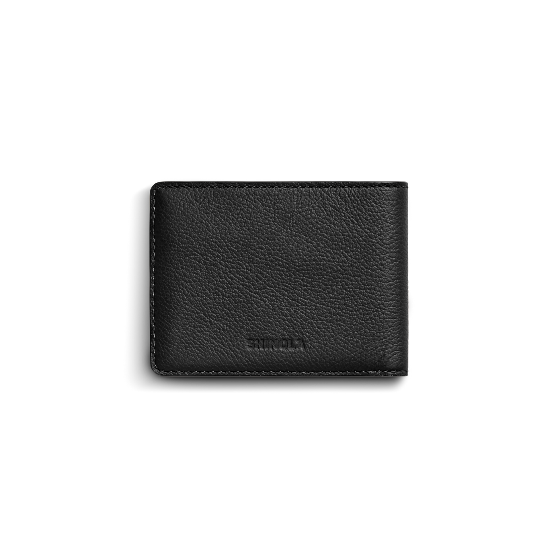 The Shinola Canfield ID Bifold Wallet in black features pebbled leather with a subtle texture and visible stitching, shown closed against a plain white background.