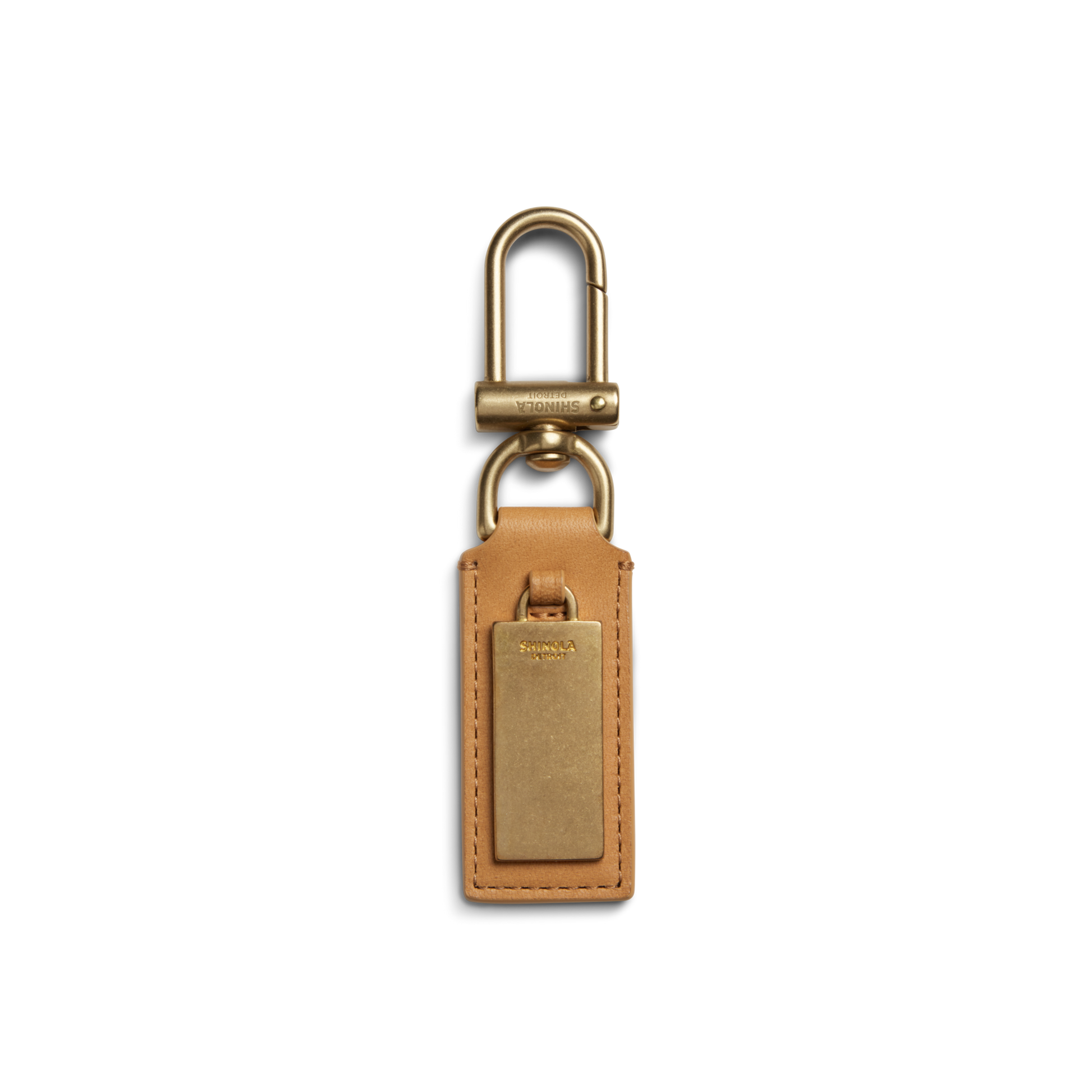 The Shinola Birdy Keychain - Honey features tan leather and a rectangular gold metal plate with a gold swivel clasp, shown on a white background—ideal as an engravable key fob for a personalized touch.