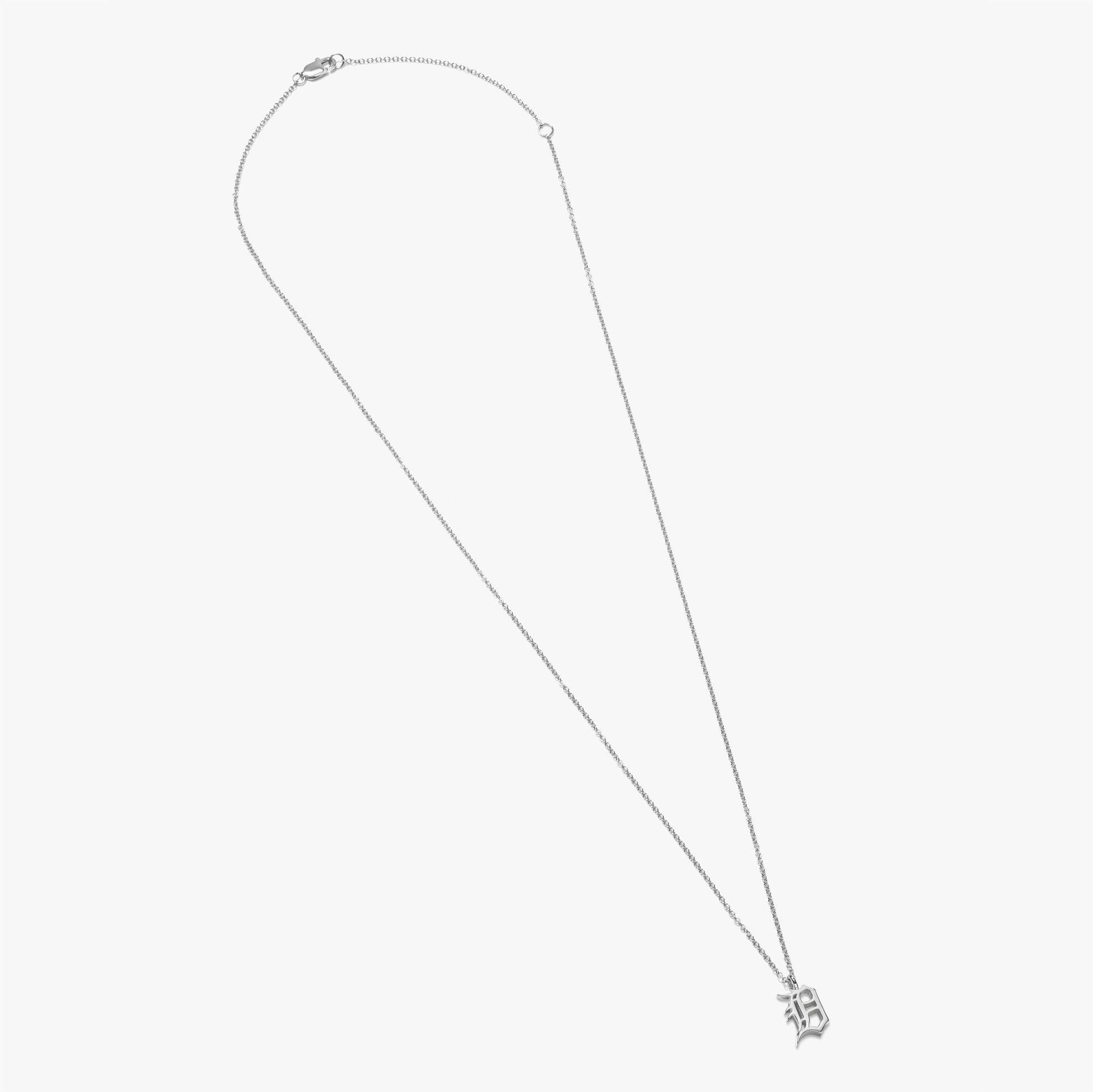 The Shinola Detroit "D" Charm Necklace features a delicate sterling silver chain with a small Old English "D" pendant, shown on a plain white background.